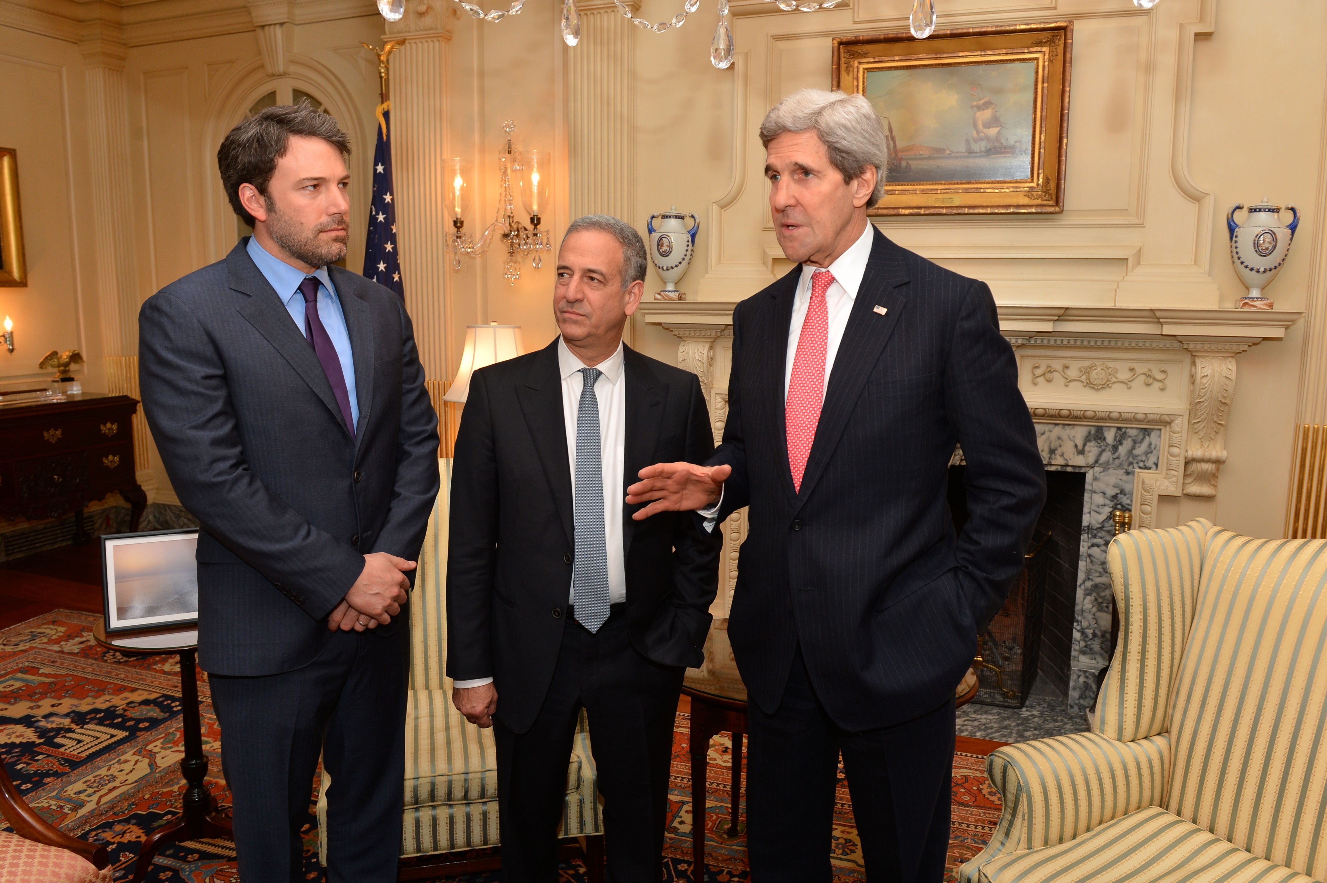 Ben Affleck in a dark suit and purple tie during a 2014 State Department meeting.