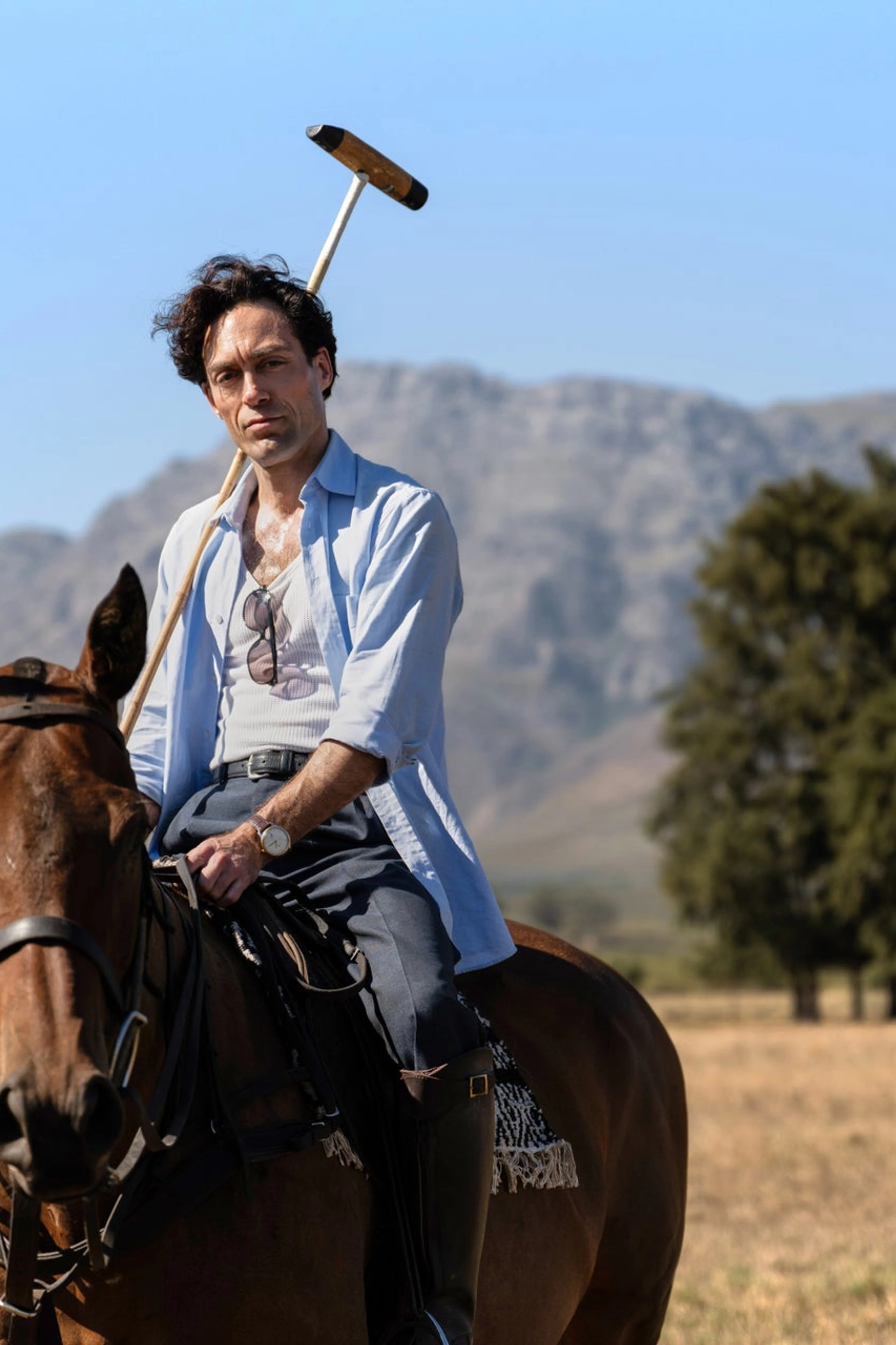 Alex Hassell as Rupert Campbell-Black sits on horseback in a Rivals Season 2 scene.