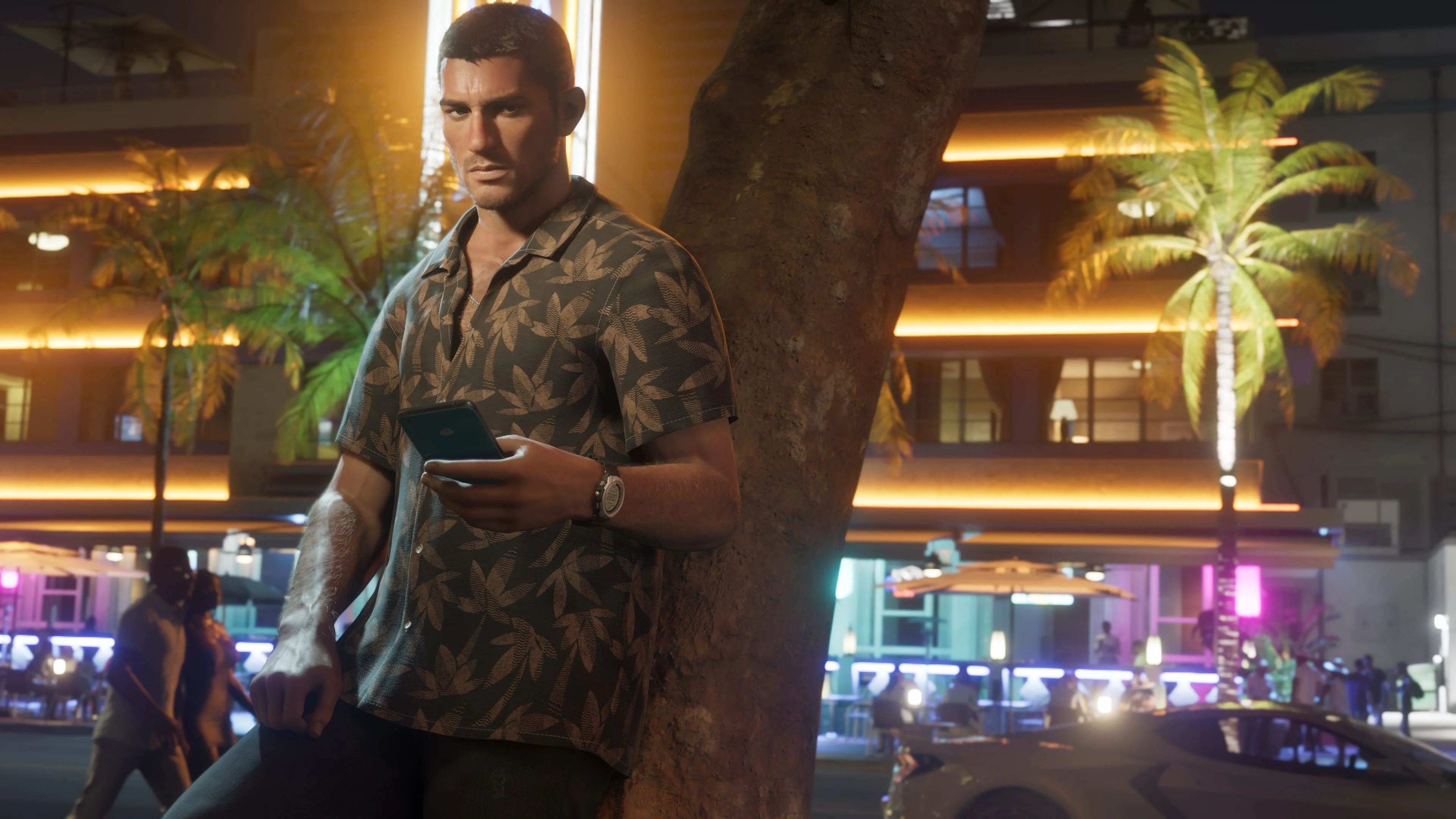 Jason checks his phone beside a tree on a neon-lit Vice City street in Grand Theft Auto VI.