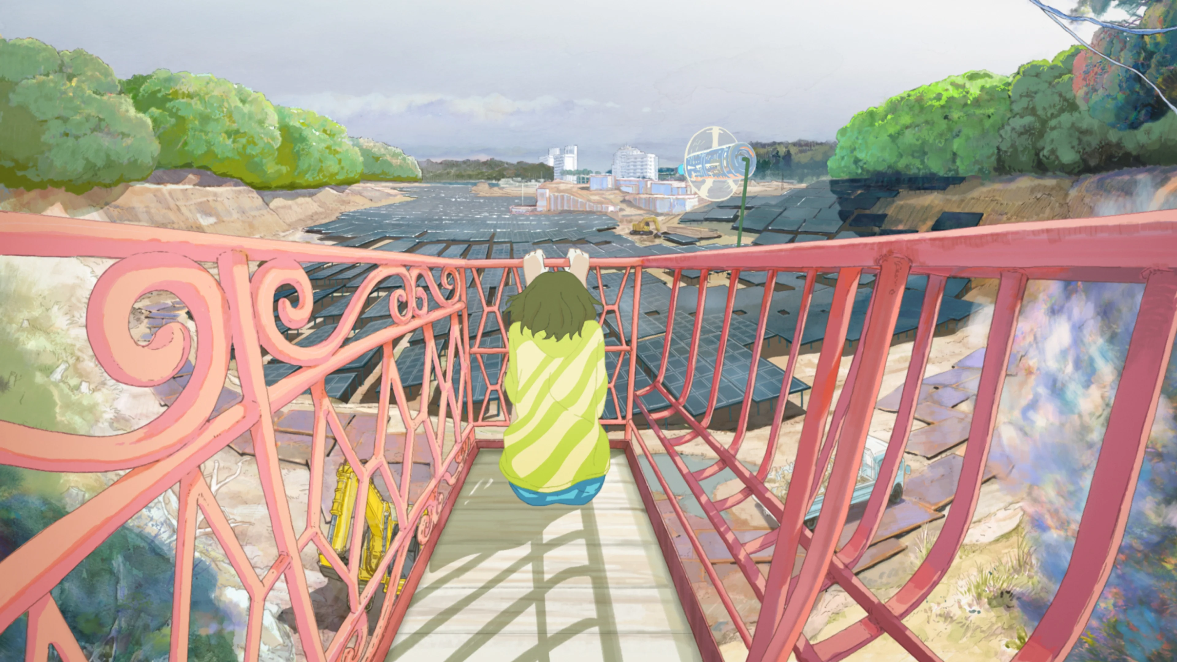 Kaoru stands on outdoor stairs above rows of solar panels, with trees and buildings beyond them.