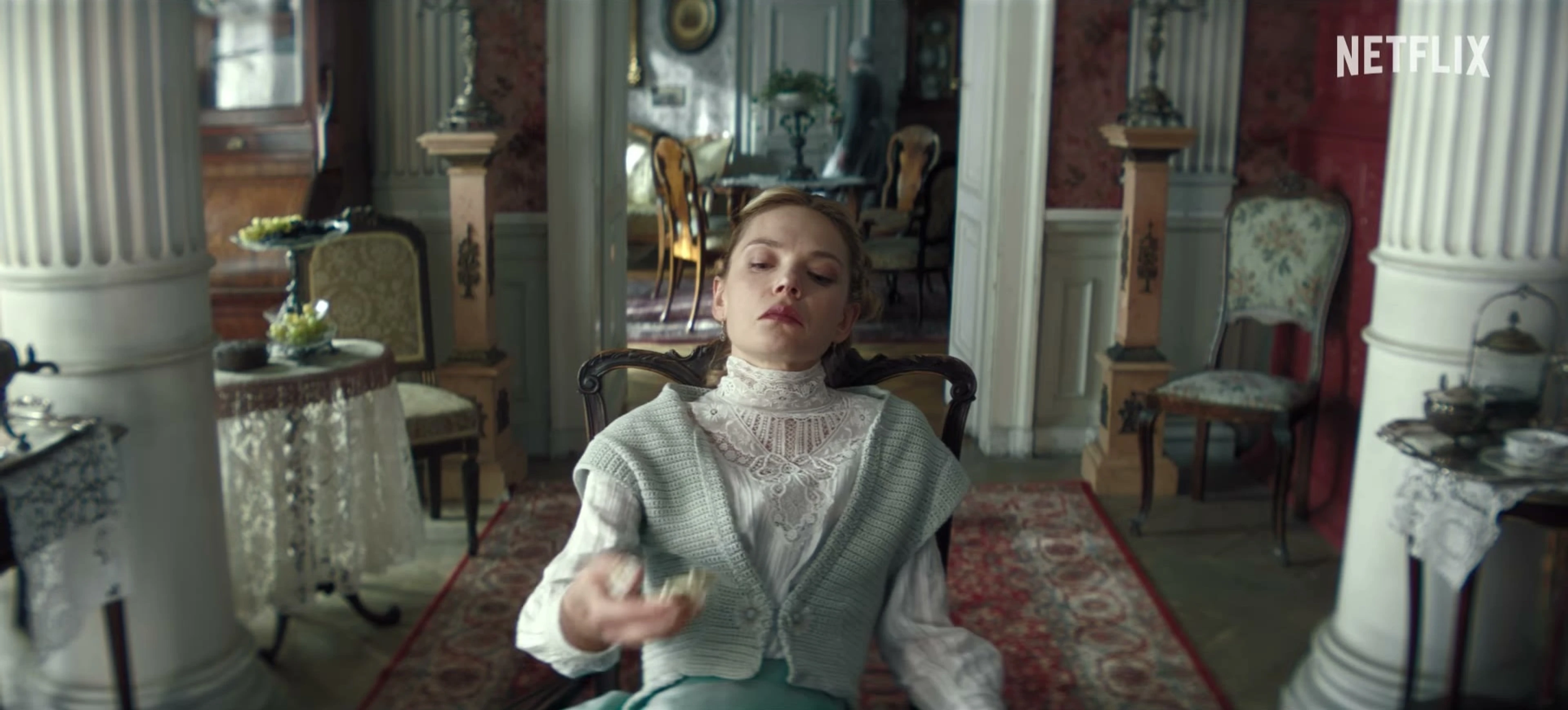 Izabela sits in a richly furnished room in Netflix’s The Doll.