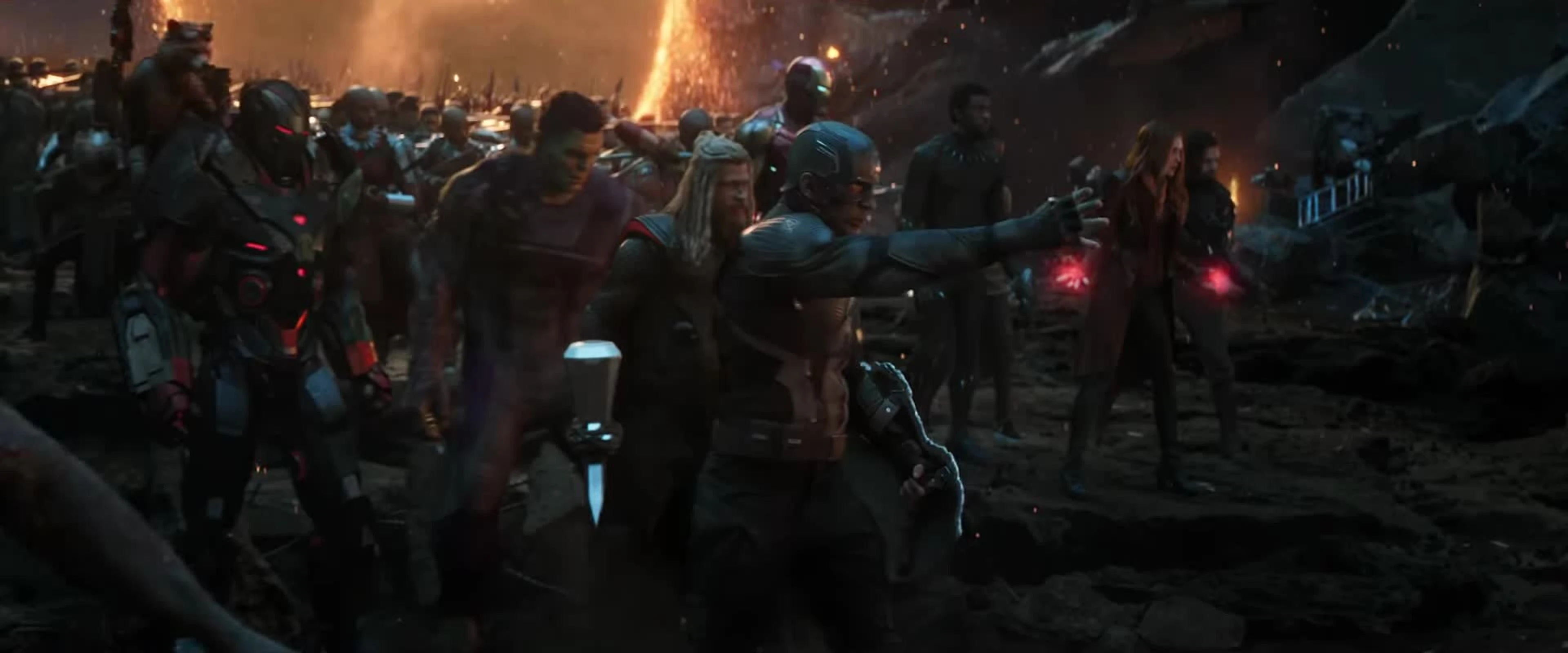 Captain America reaches forward as Avengers gather behind him during the final battle in Avengers: Endgame.