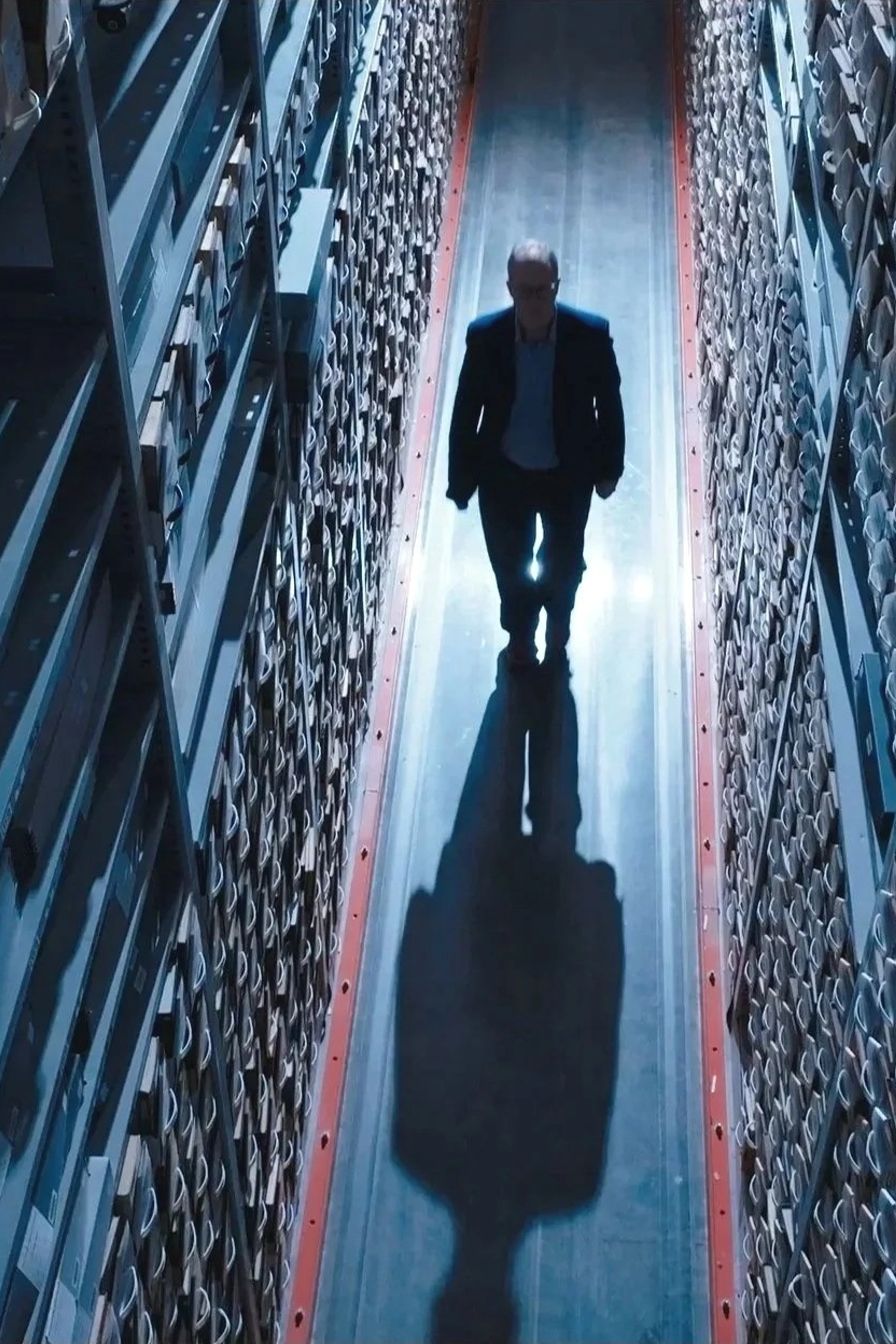 An unidentified person walks among archive files at the Center for the Impossible.