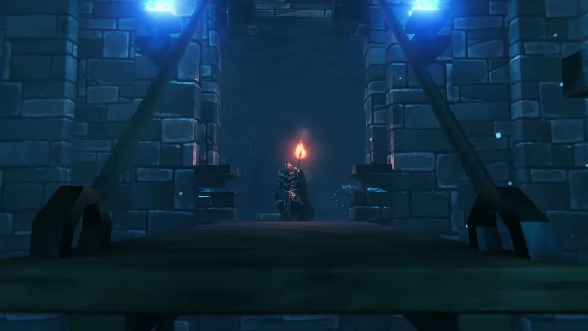 An armored Viking carrying a torch enters a blue-lit stone fortress in Valheim’s Deep North.
