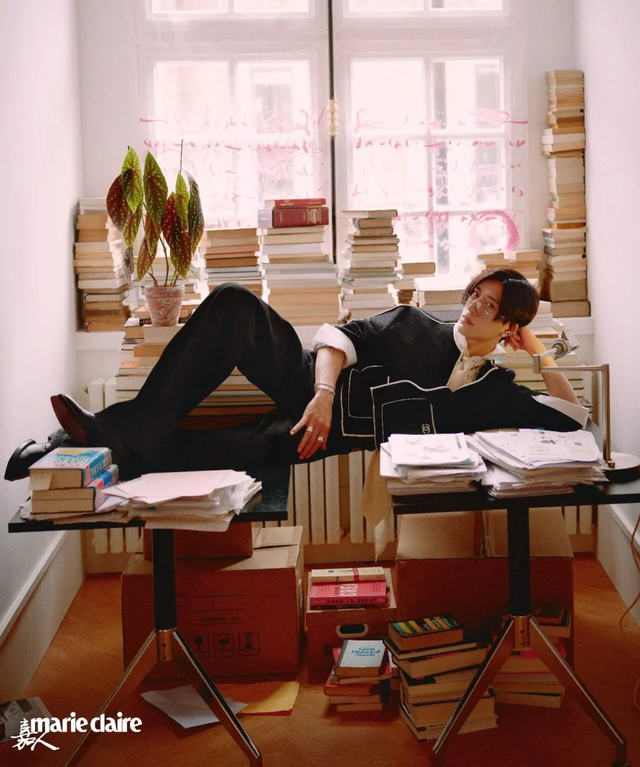 Jing Boran reclining among books in a Marie Claire China fashion photograph.