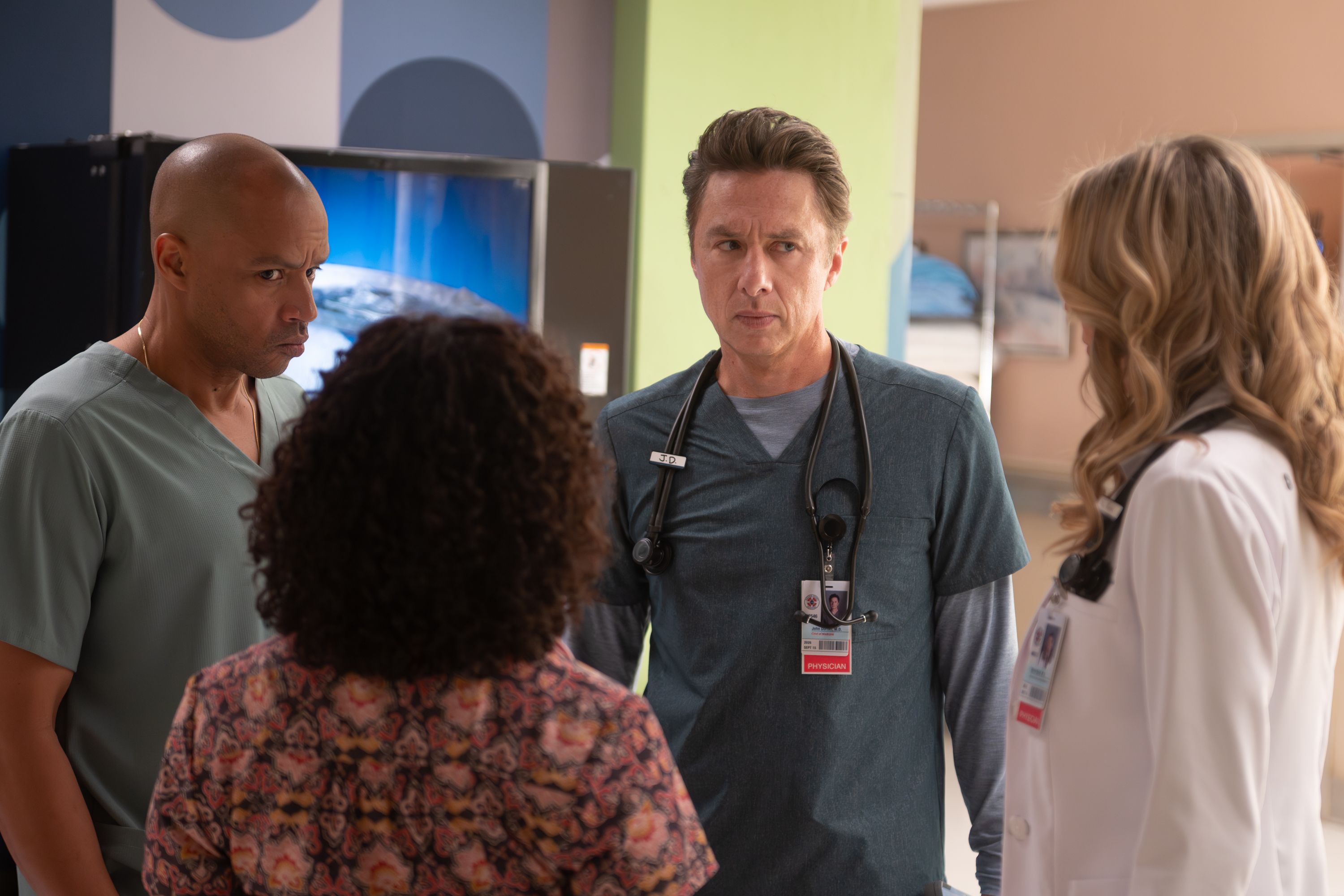 Zach Braff as J.D. talks with doctors at Sacred Heart.