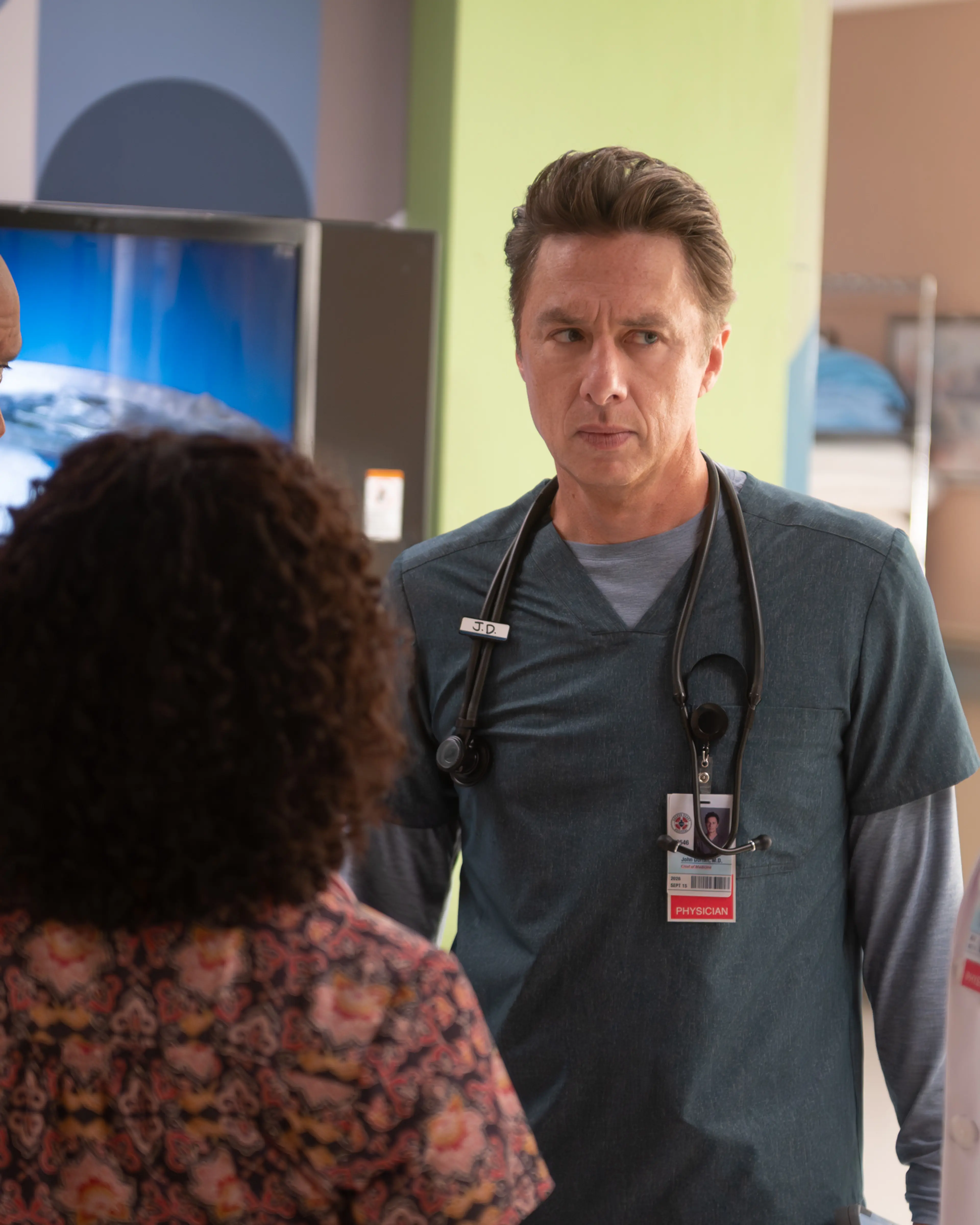 Zach Braff as J.D. talks with doctors at Sacred Heart.