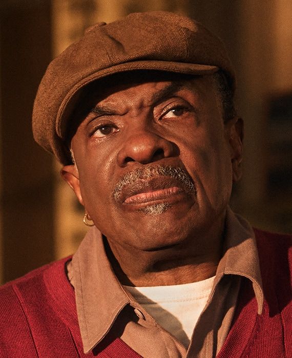 Keith David wears Marty’s cap and red cardigan.