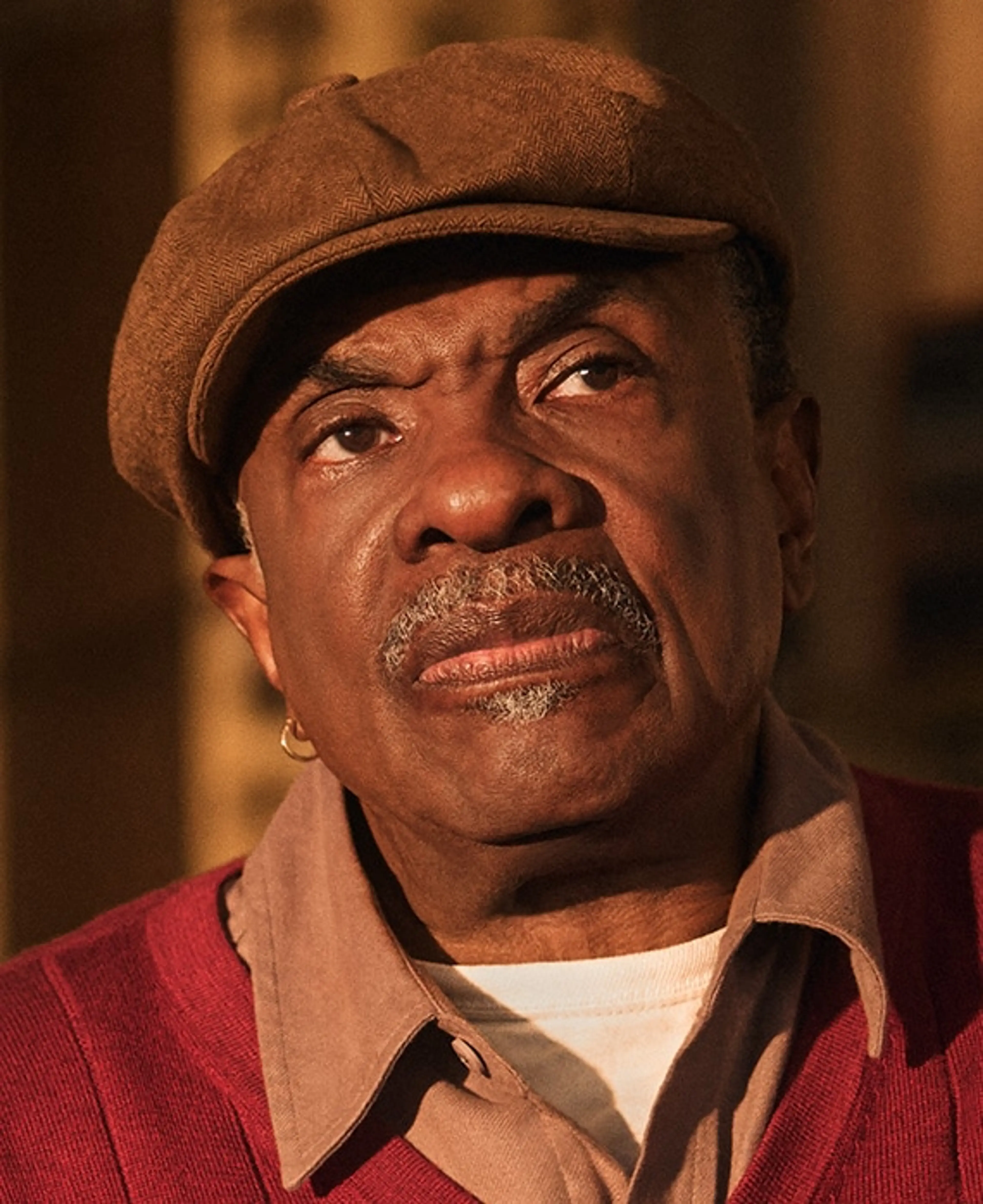Keith David wears Marty’s cap and red cardigan.