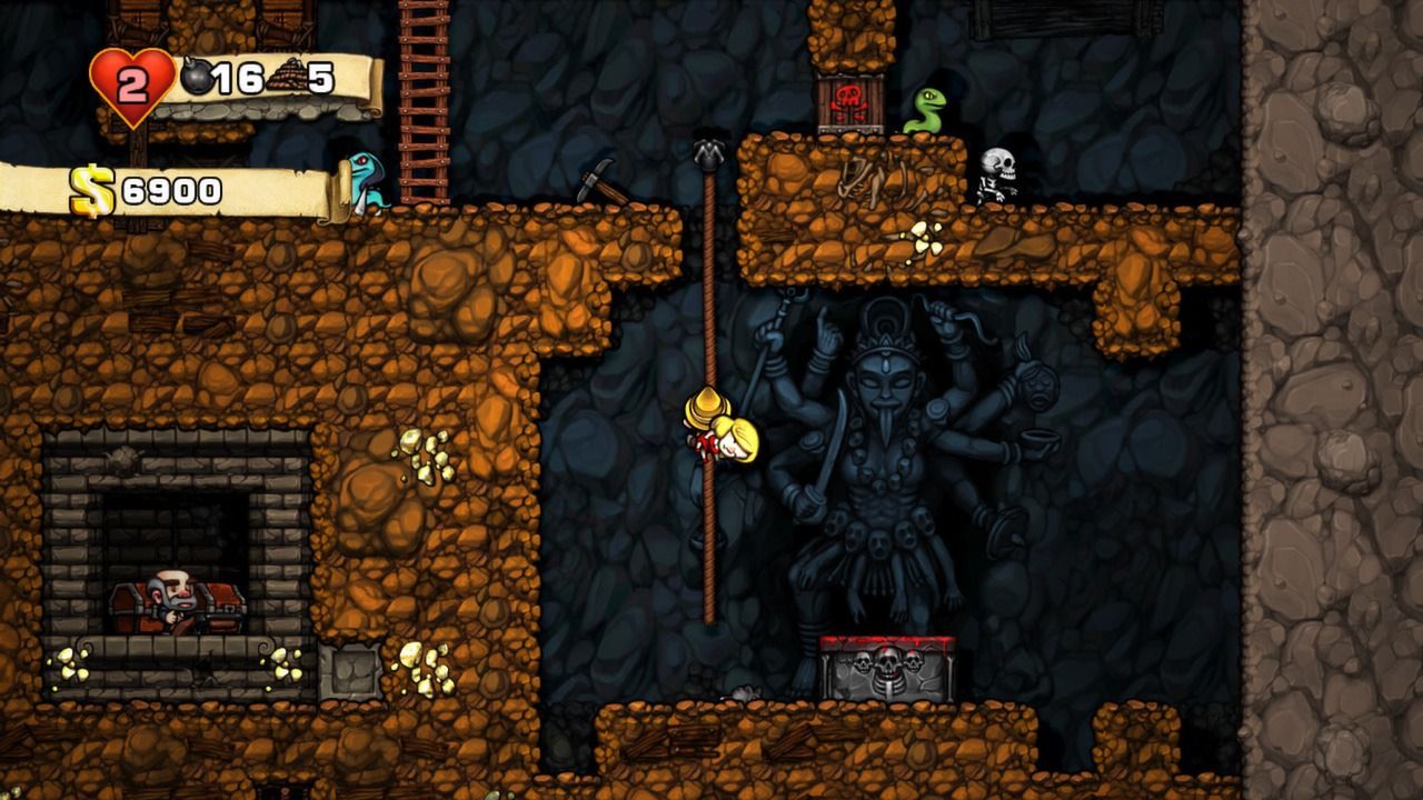 Close view of a Spelunky explorer climbing a rope with stone ledges and enemies above.