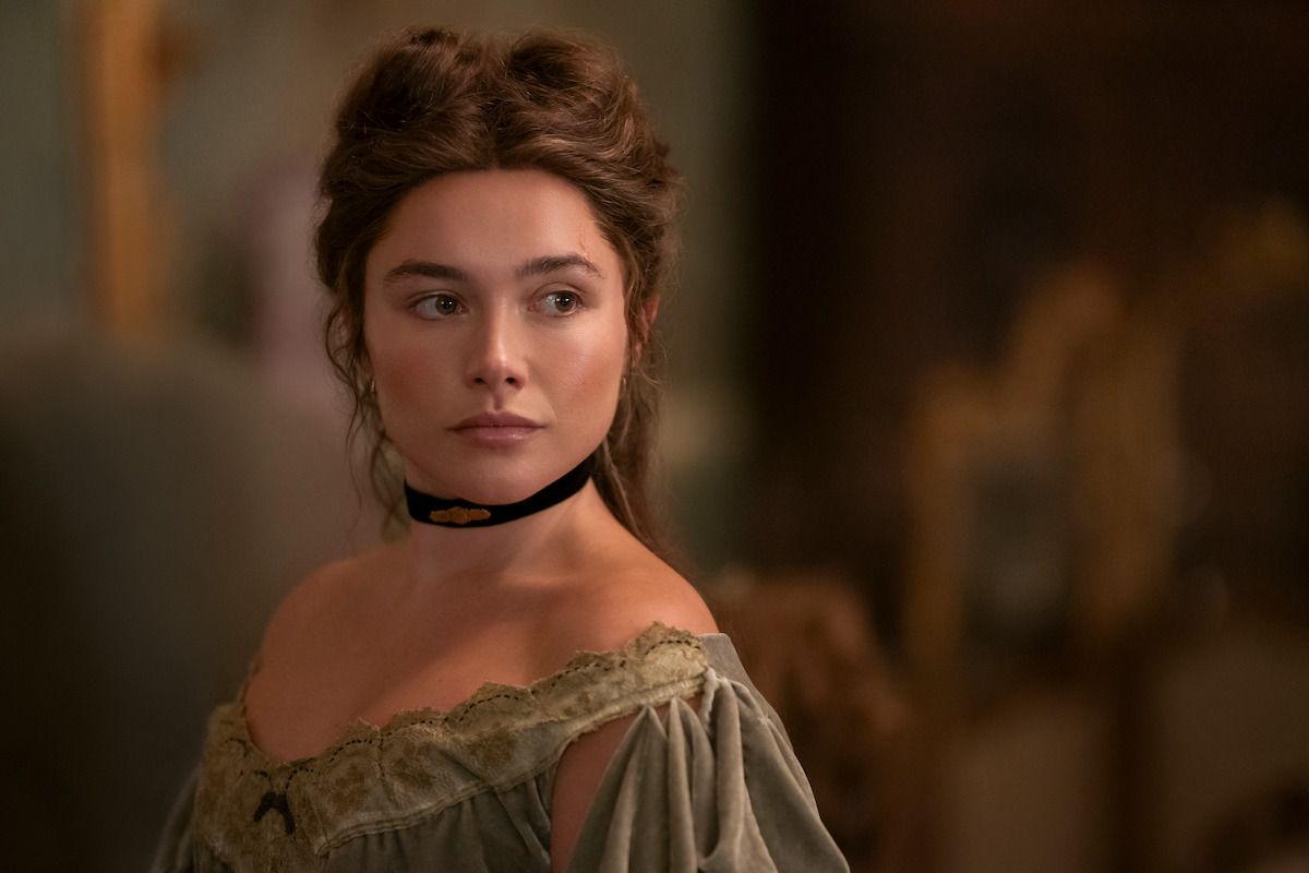 Florence Pugh as Cathy Ames wears a black choker and period dress in East of Eden.