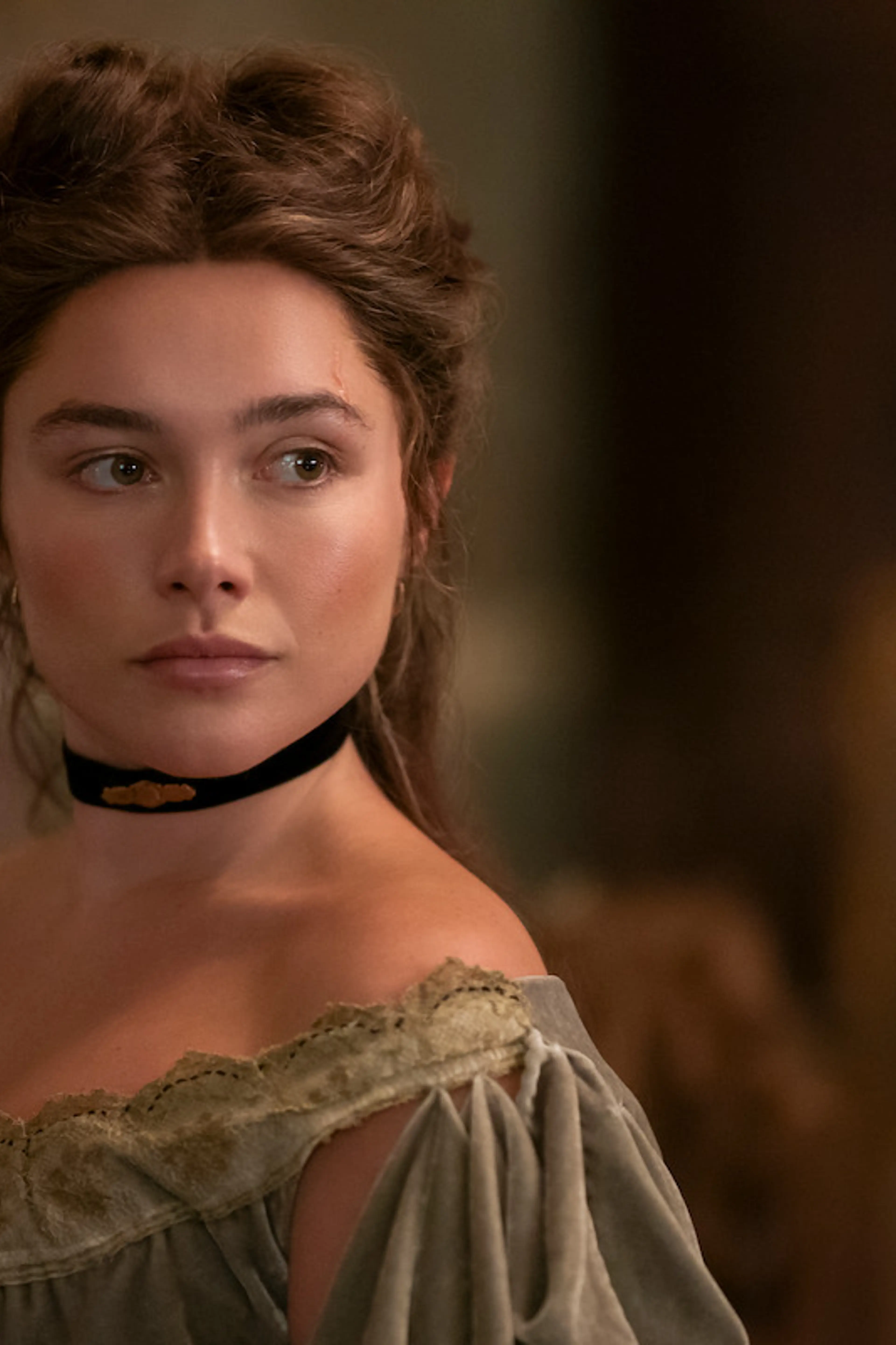 Florence Pugh as Cathy Ames wears a black choker and period dress in East of Eden.