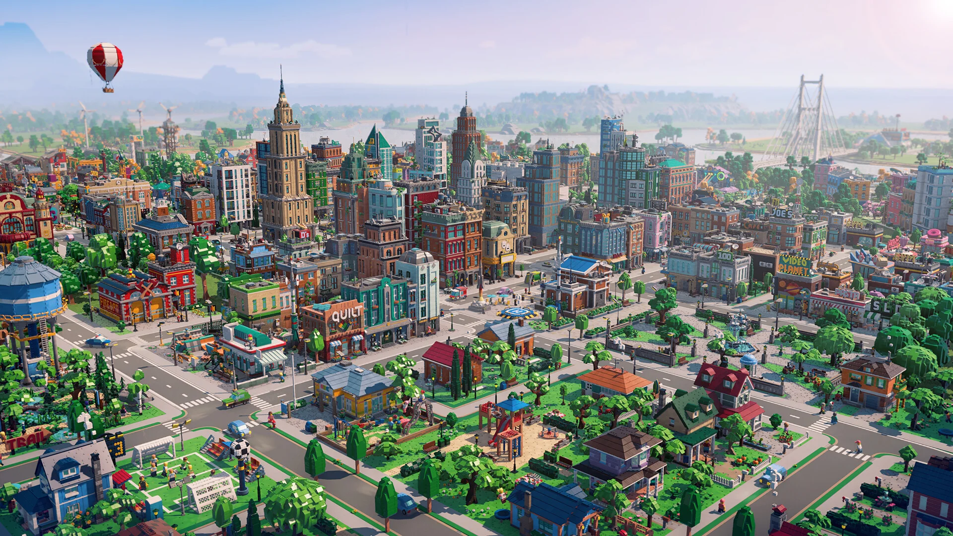 A large LEGO Skylines city with downtown towers, homes, parks, roads, and a bridge