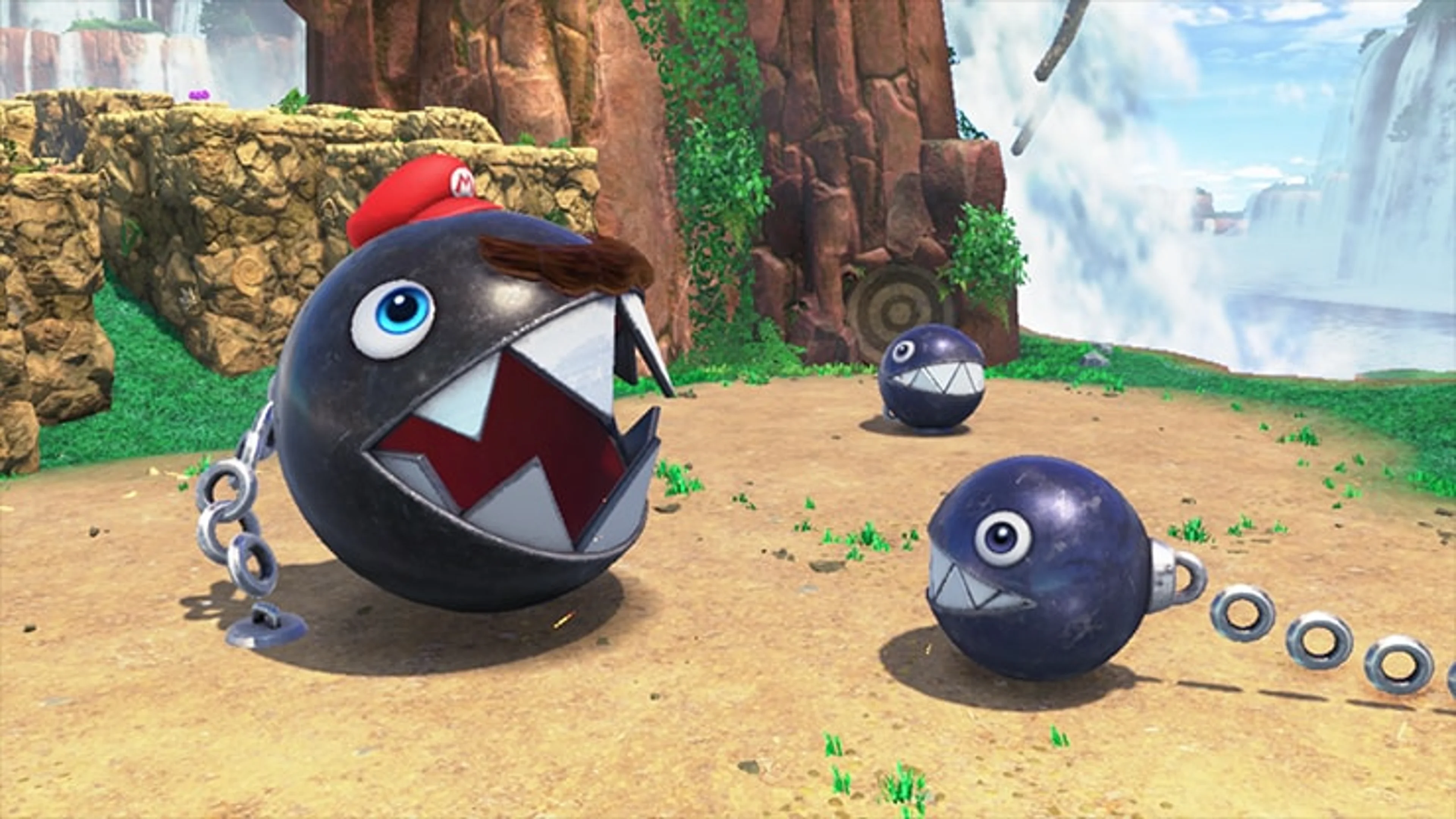 An official gameplay screenshot shows a black Chain Chomp with large white teeth attached to a chain in Cascade Kingdom.