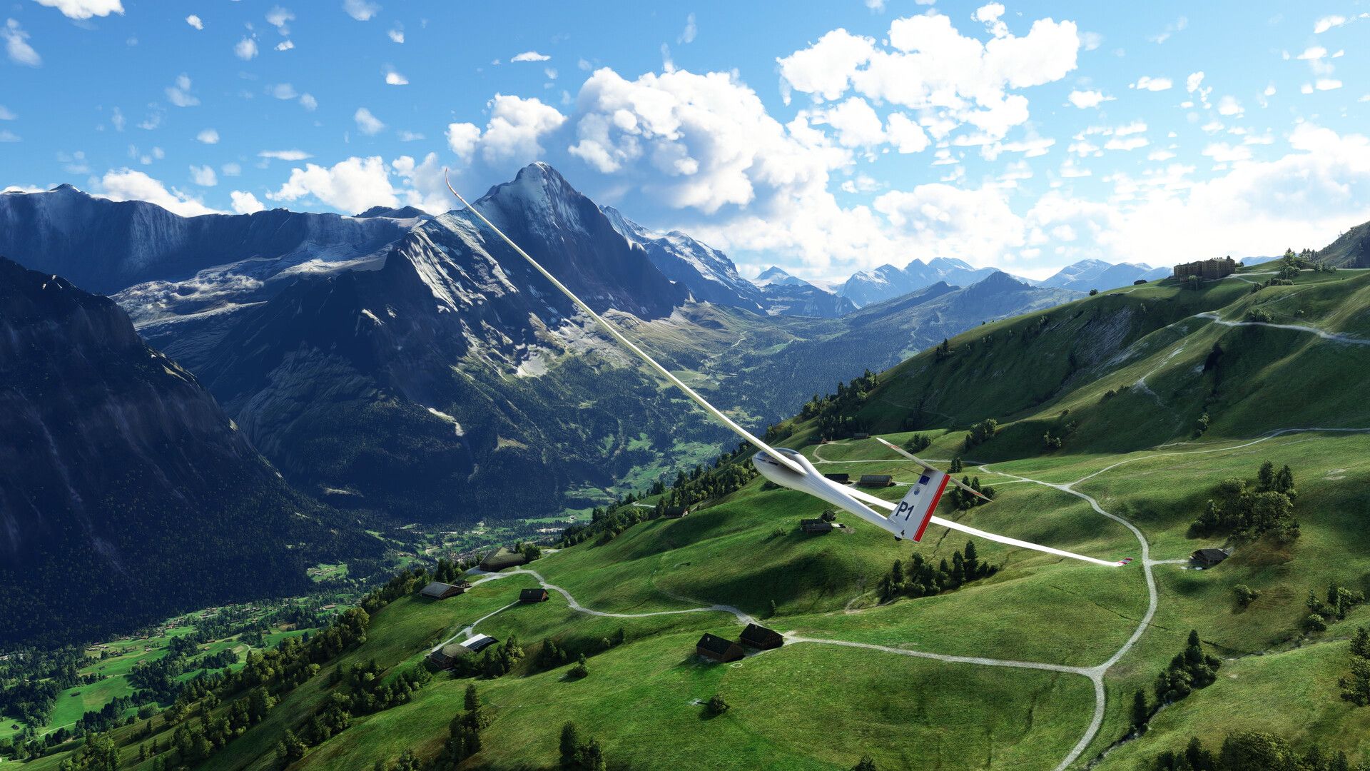 A small plane passes over a green mountain valley.