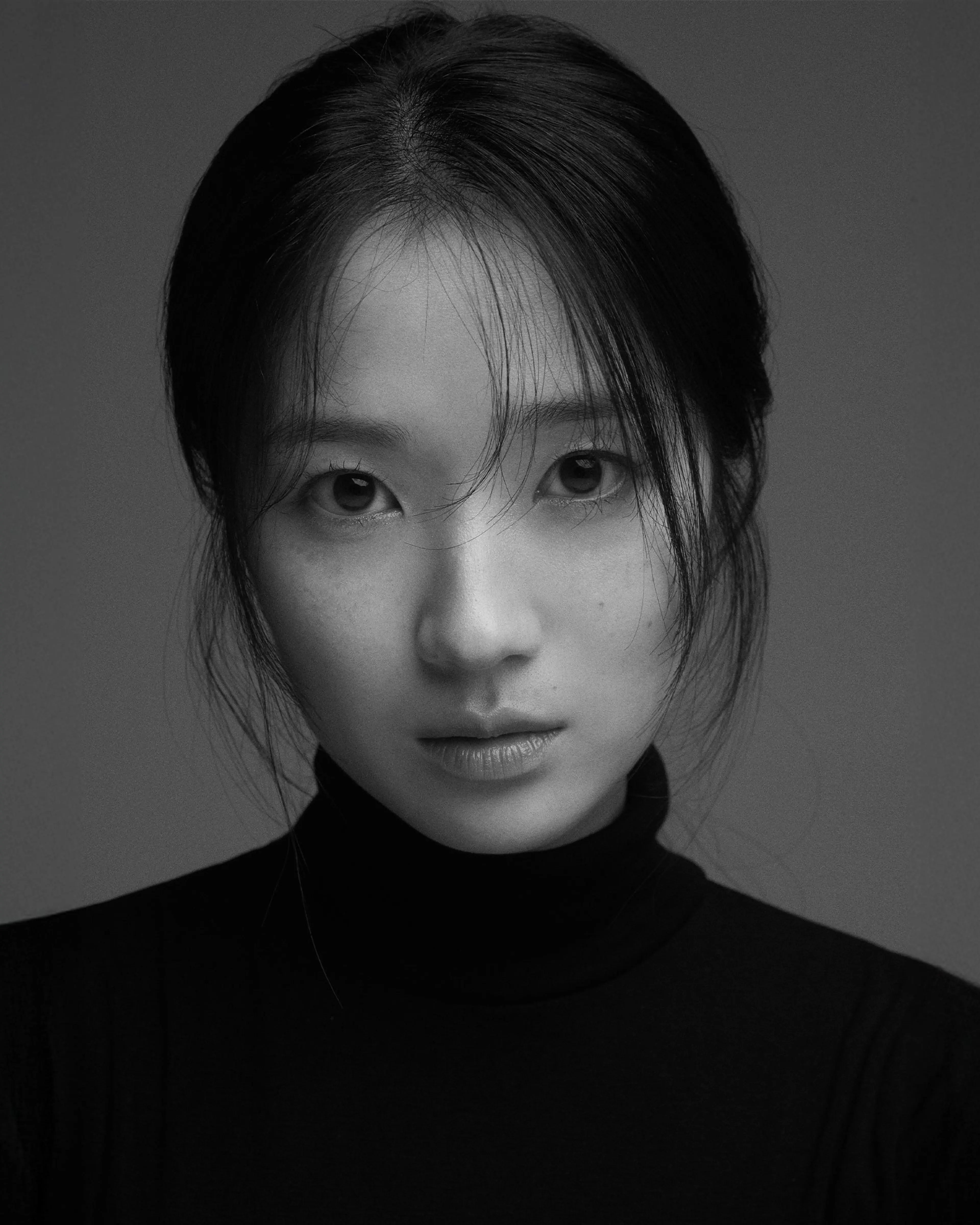 Kim Hye-yoon in a black-and-white portrait from her official agency profile.