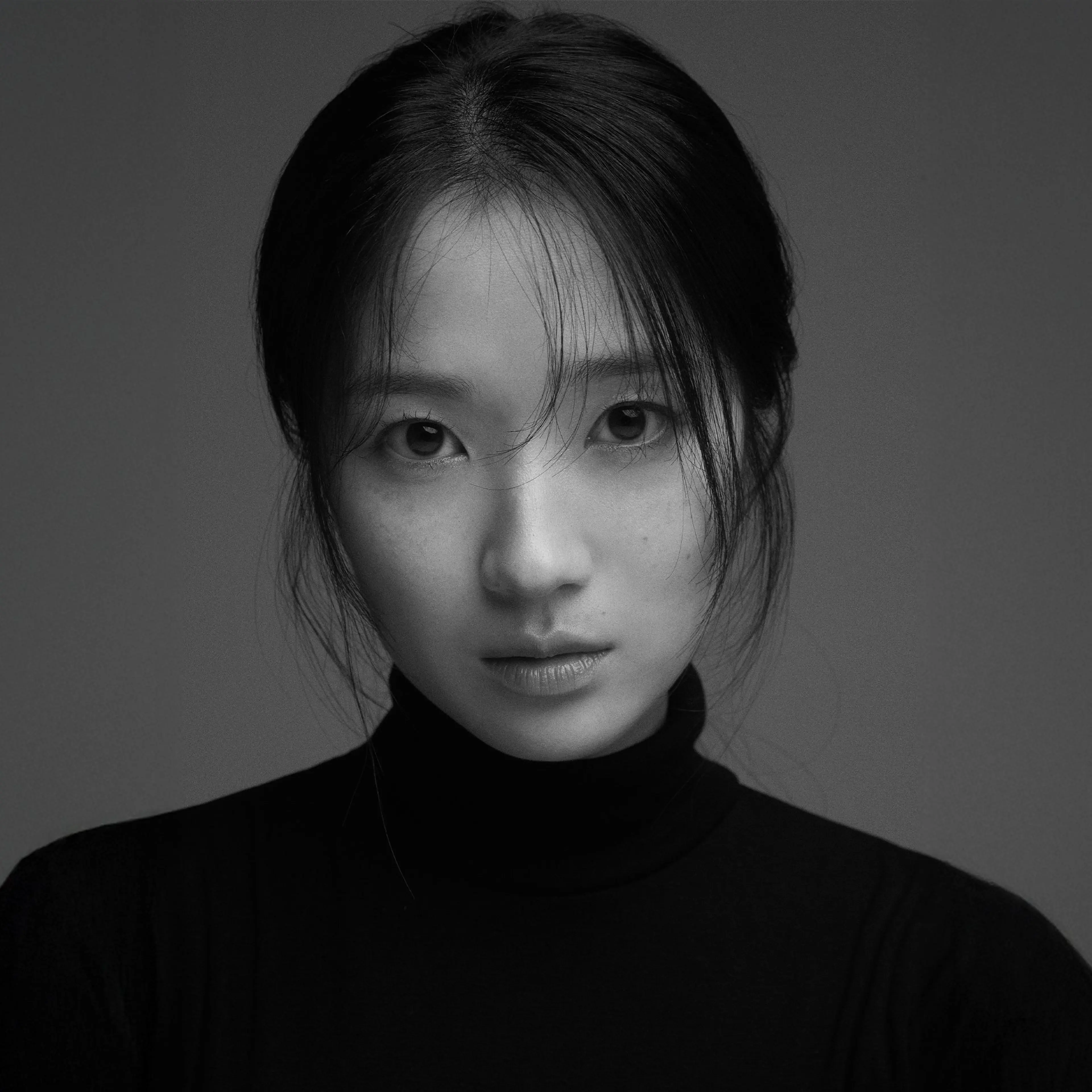 Kim Hye-yoon in a black-and-white portrait from her official agency profile.