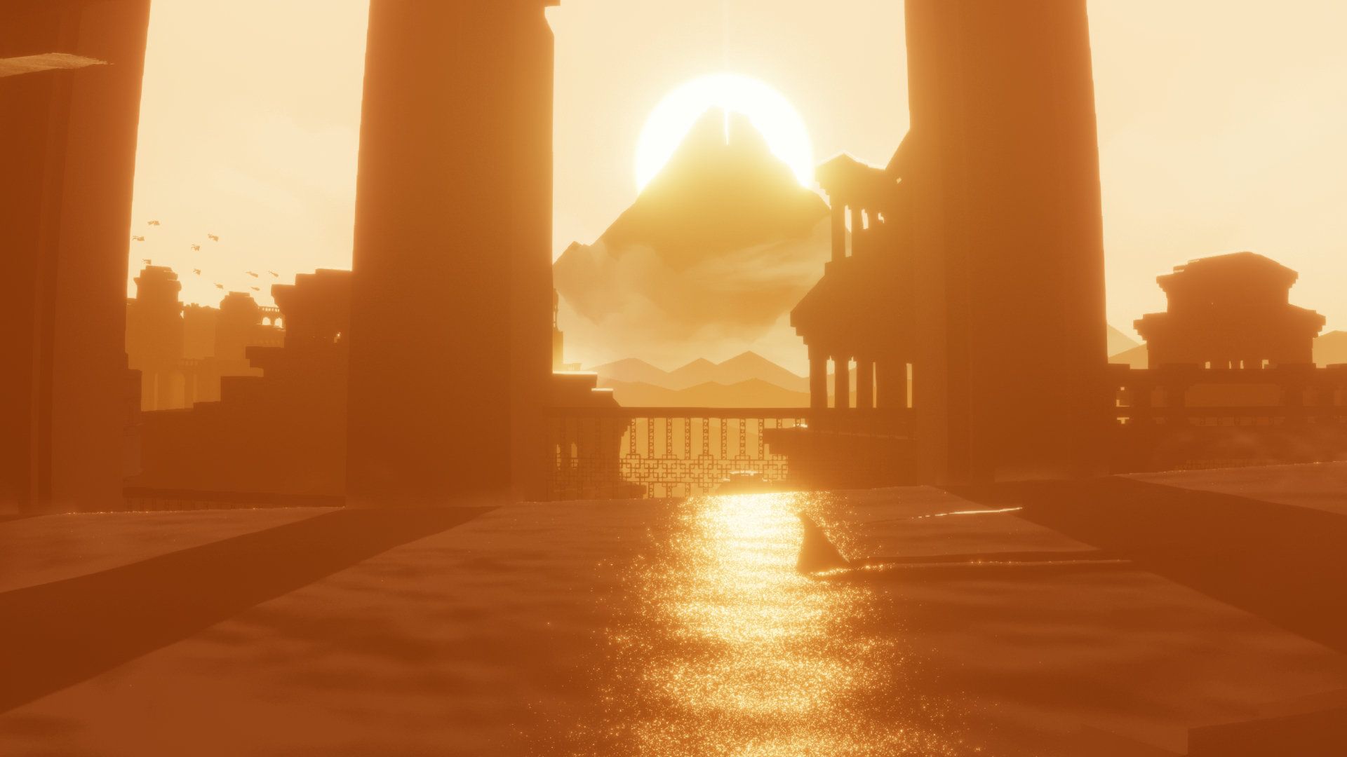The mountain is framed by two dark pillars beyond a sunlit courtyard.