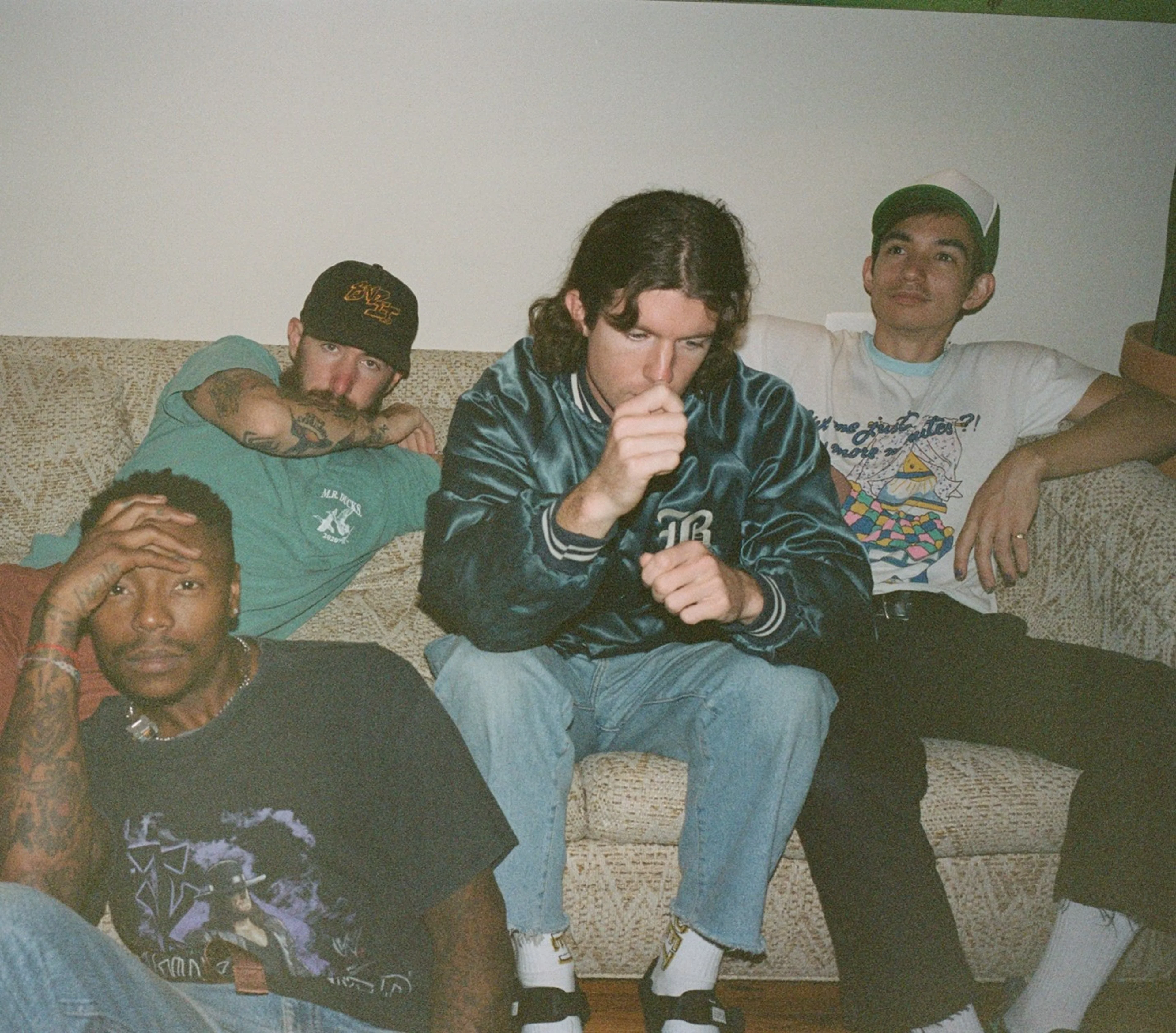 Turnstile members sit together in an archival 2022 press portrait.