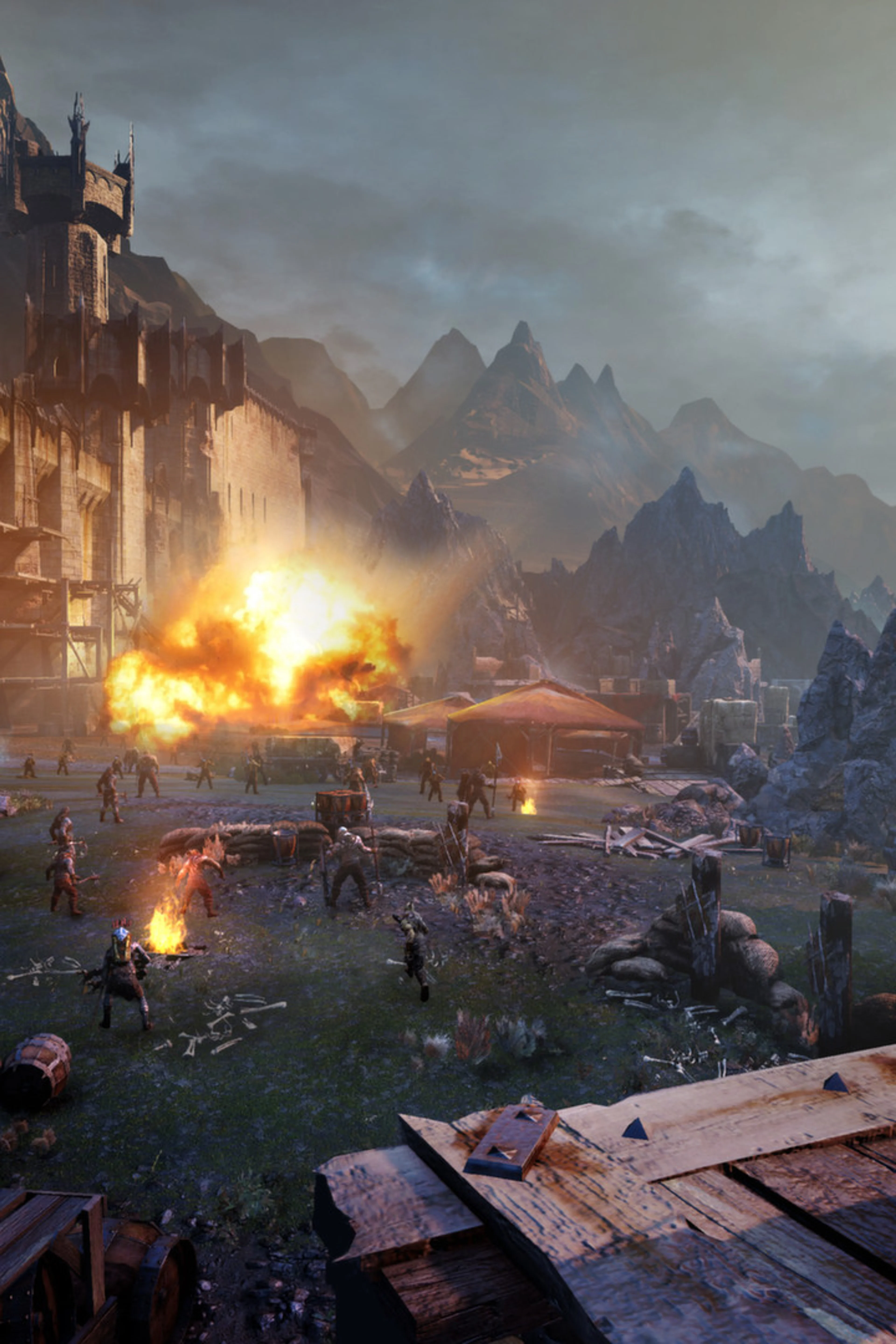 Talion looks across a besieged fortress in a Shadow of Mordor screenshot.