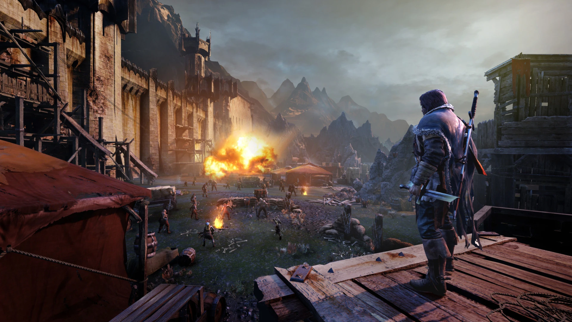 Talion looks across a besieged fortress in a Shadow of Mordor screenshot.