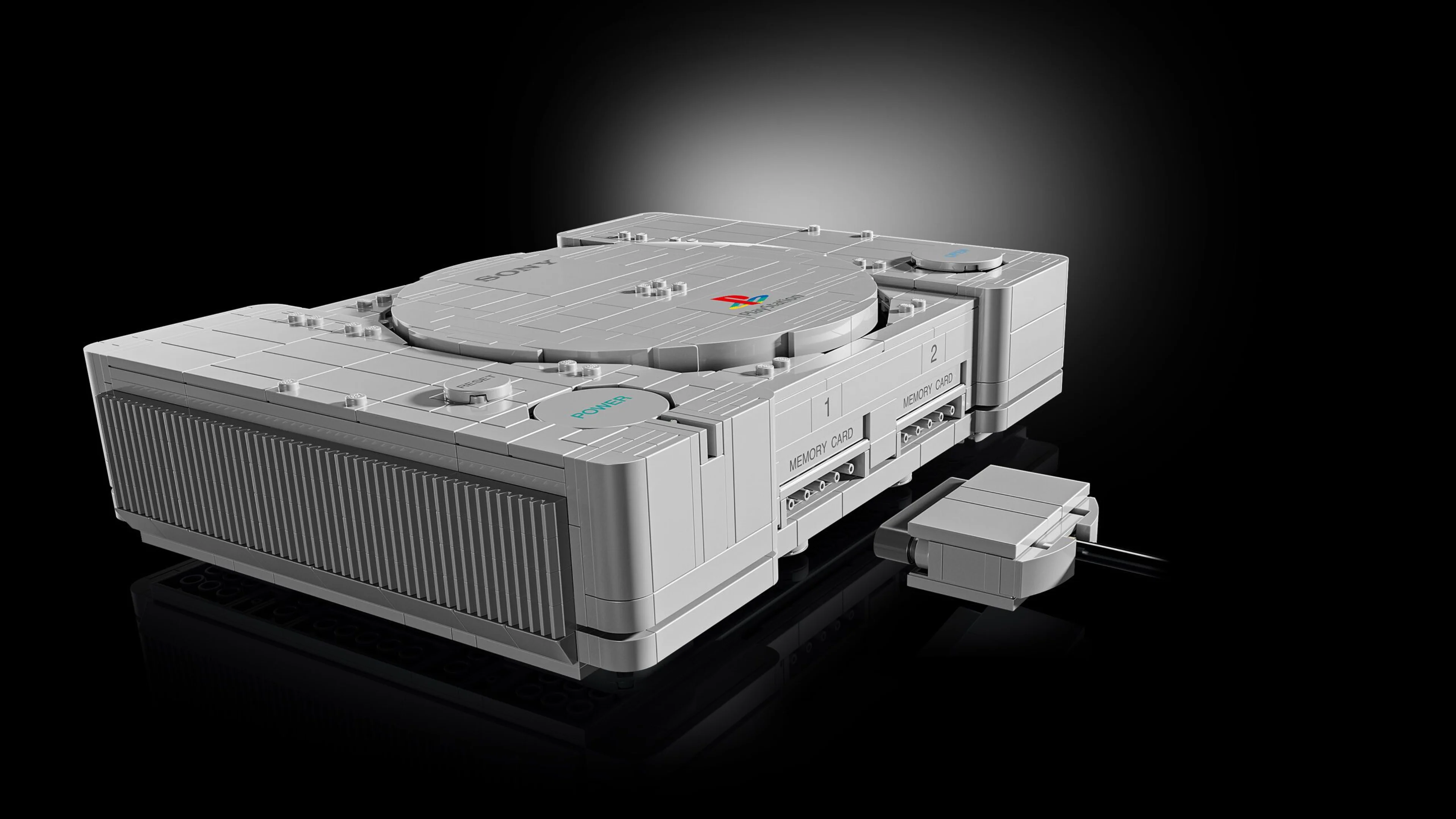 The LEGO PlayStation console is open to show its hidden Gran Turismo and Ape Escape scenes.
