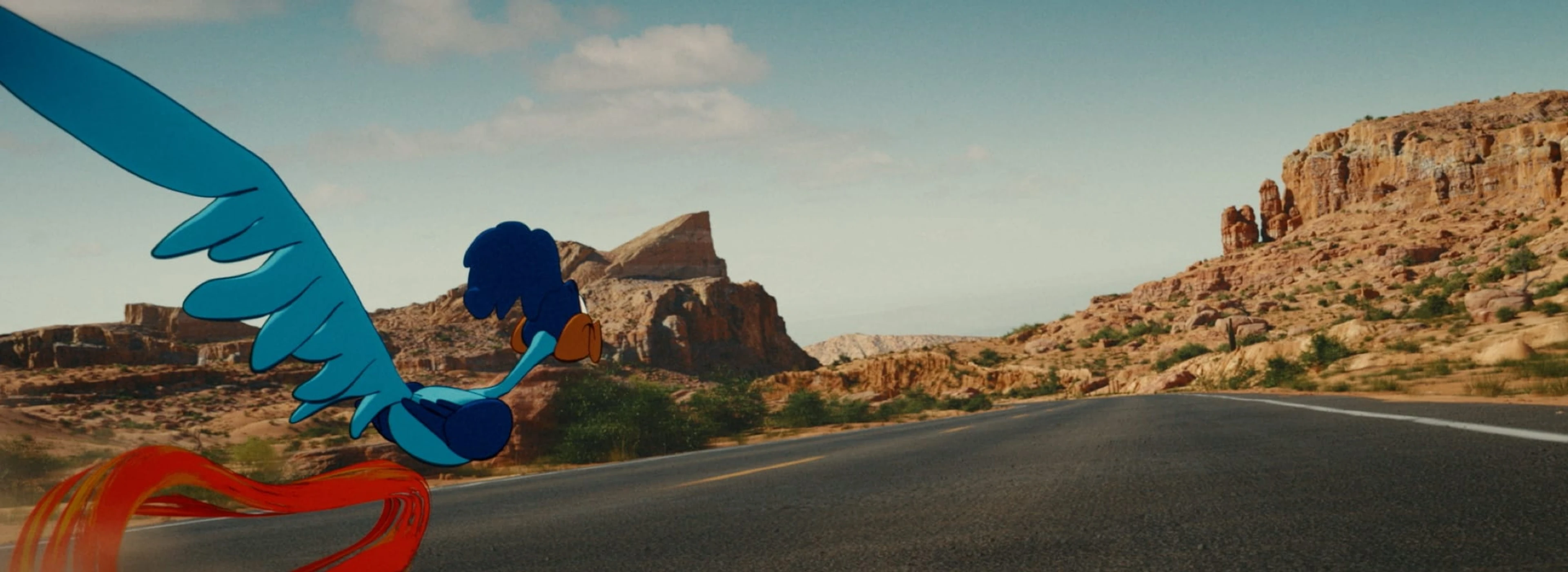Wile E. Coyote races down a desert road in a colorful Coyote vs. Acme scene.
