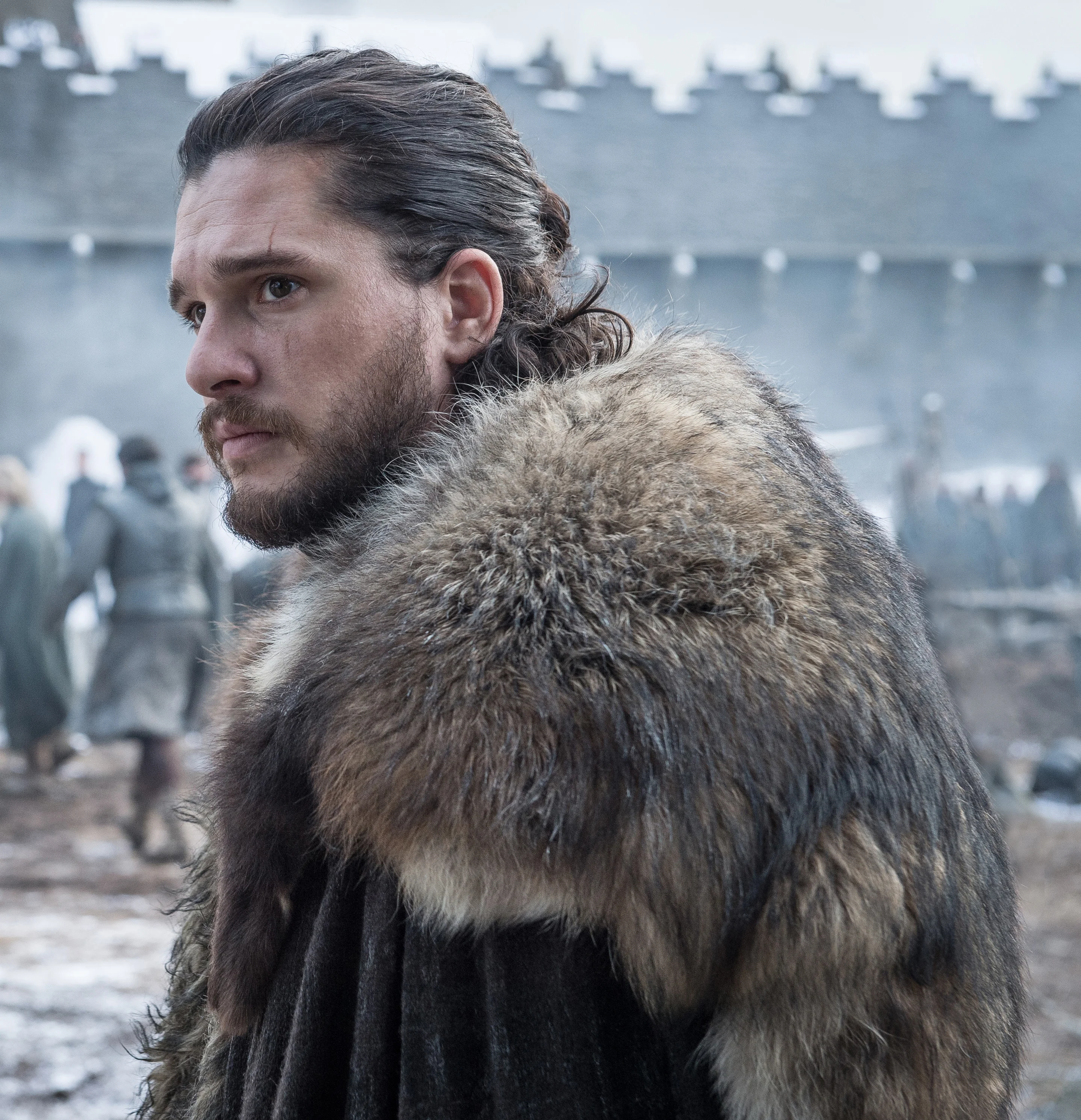 Kit Harington wears Jon Snow’s black armor and fur cloak in Game of Thrones.
