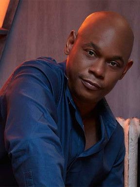 Portrait of Bokeem Woodbine in a blue shirt.