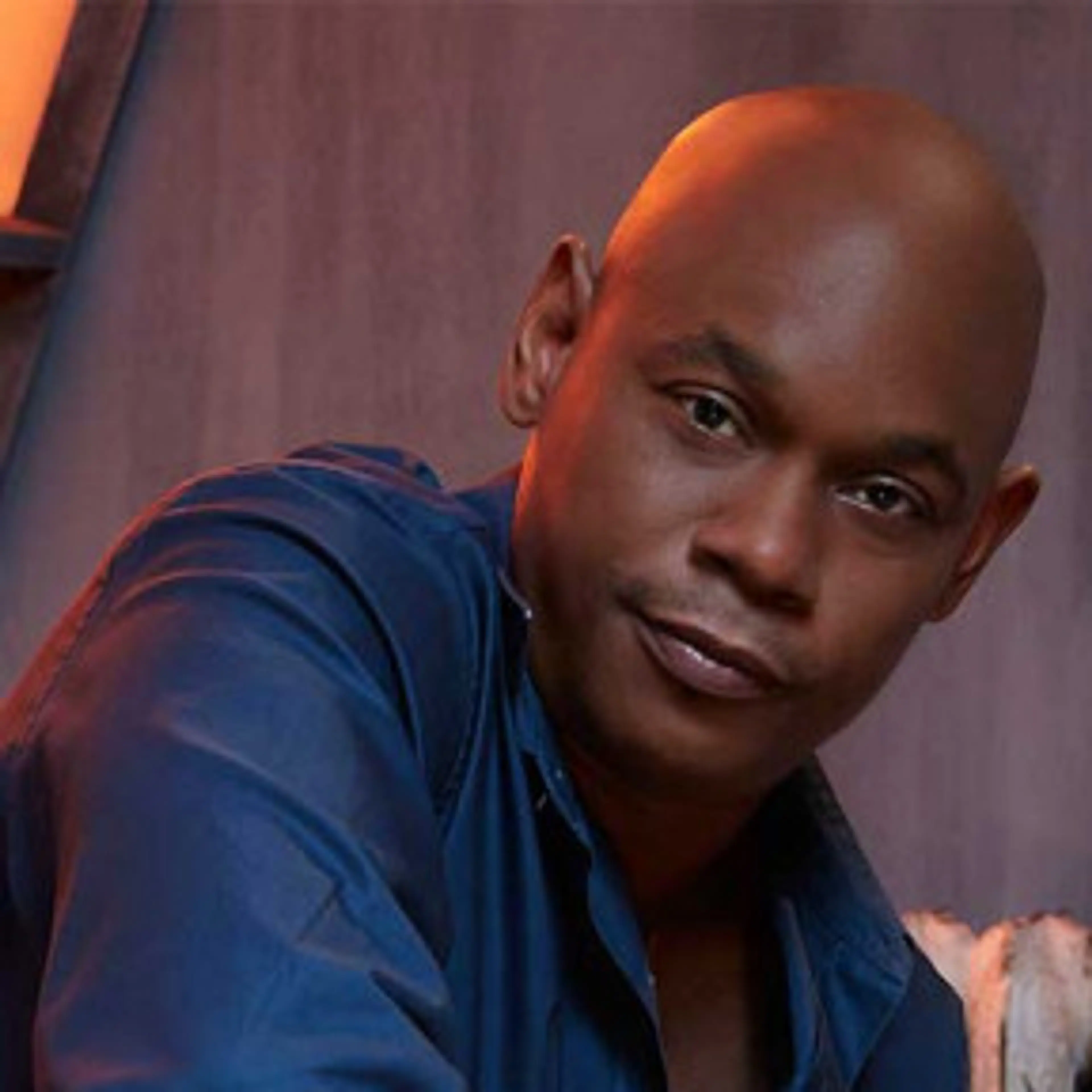 Portrait of Bokeem Woodbine in a blue shirt.