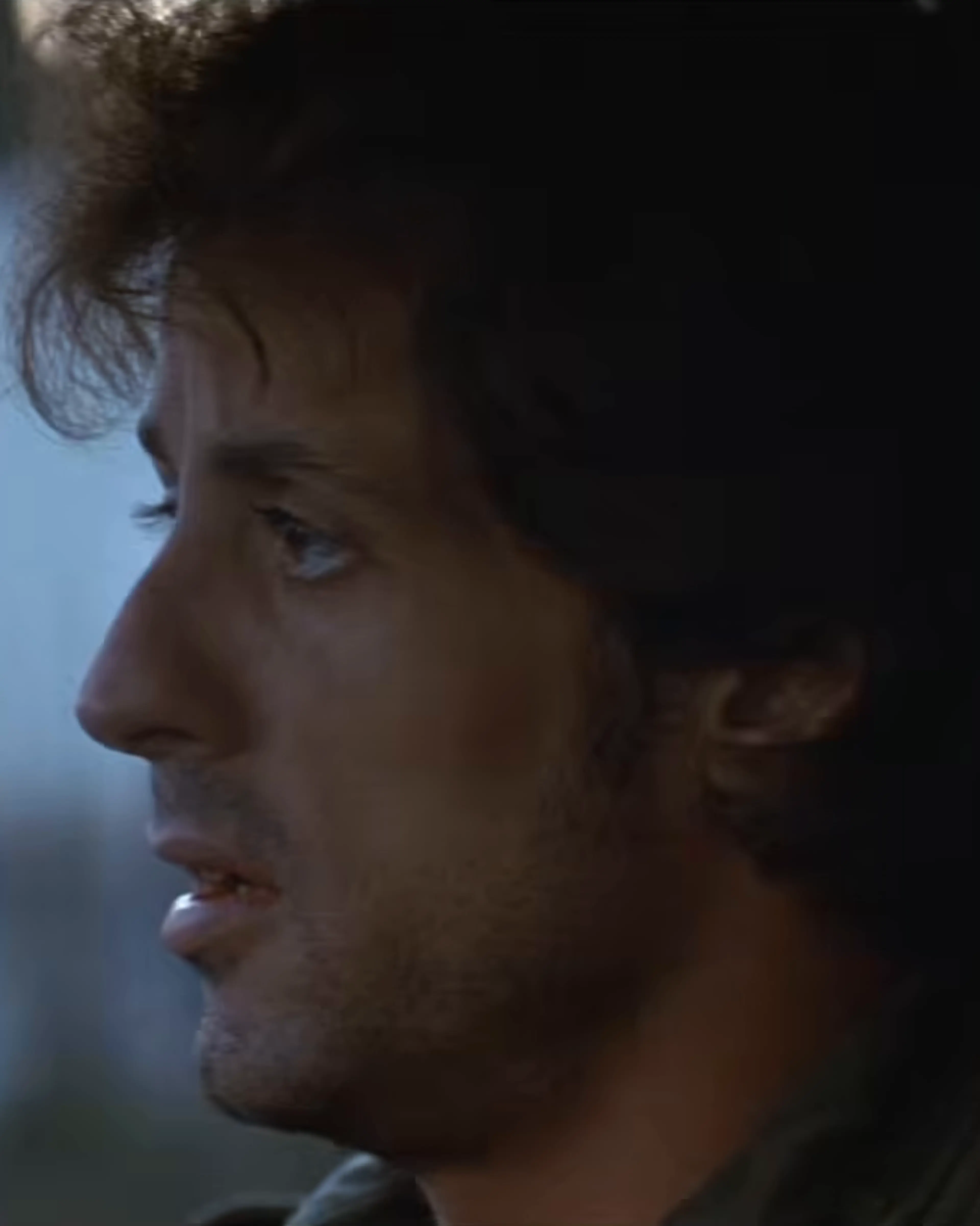 Sylvester Stallone as John Rambo looks out from the passenger seat of a vehicle.