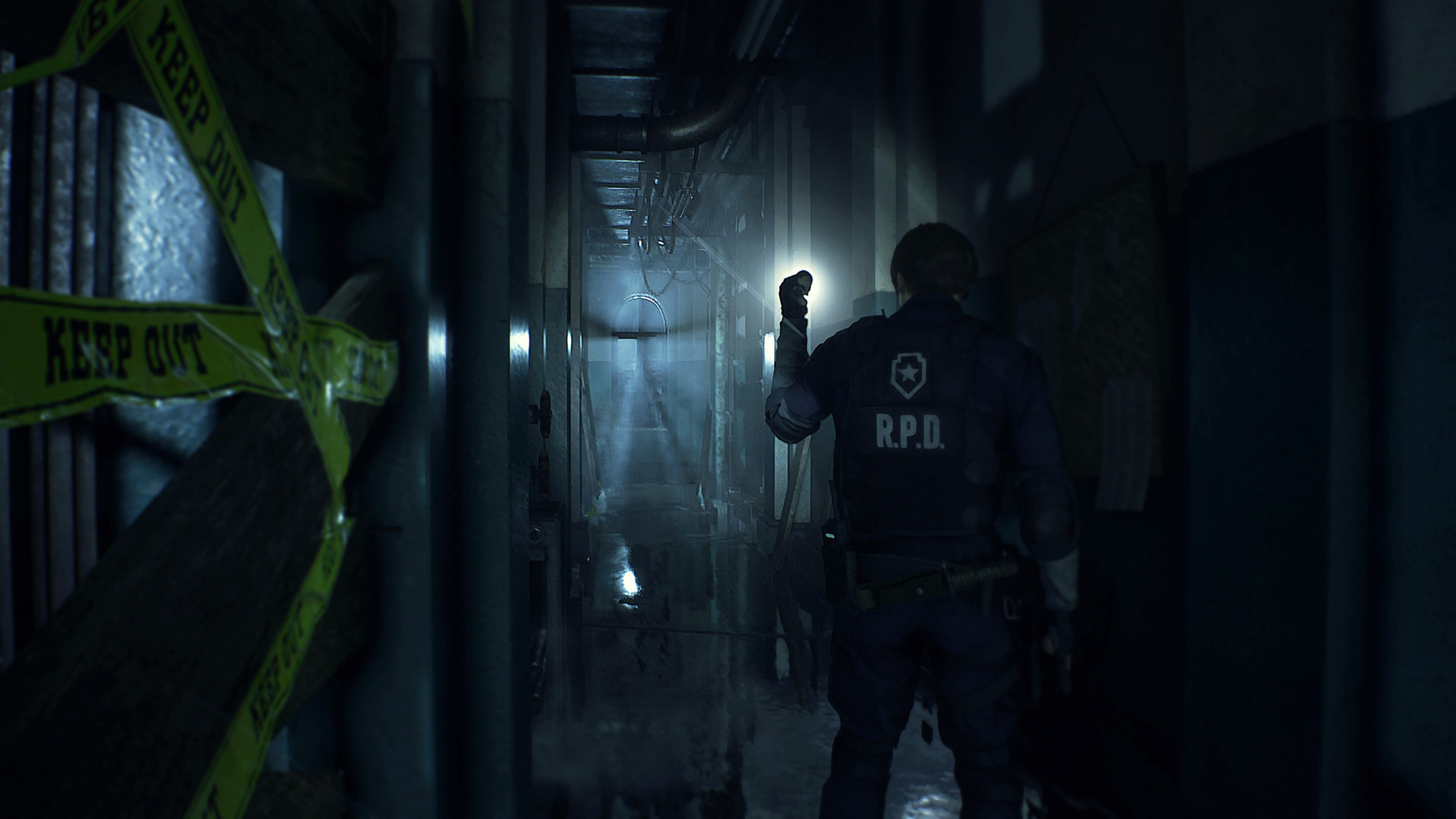 Leon explores a dark corridor inside the Raccoon Police Department.