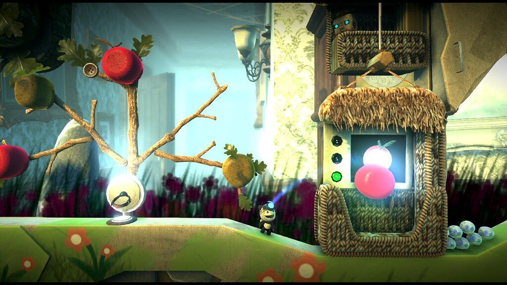Sackboy in a Move Pack preview level with hanging shapes and a decorated wooden panel.