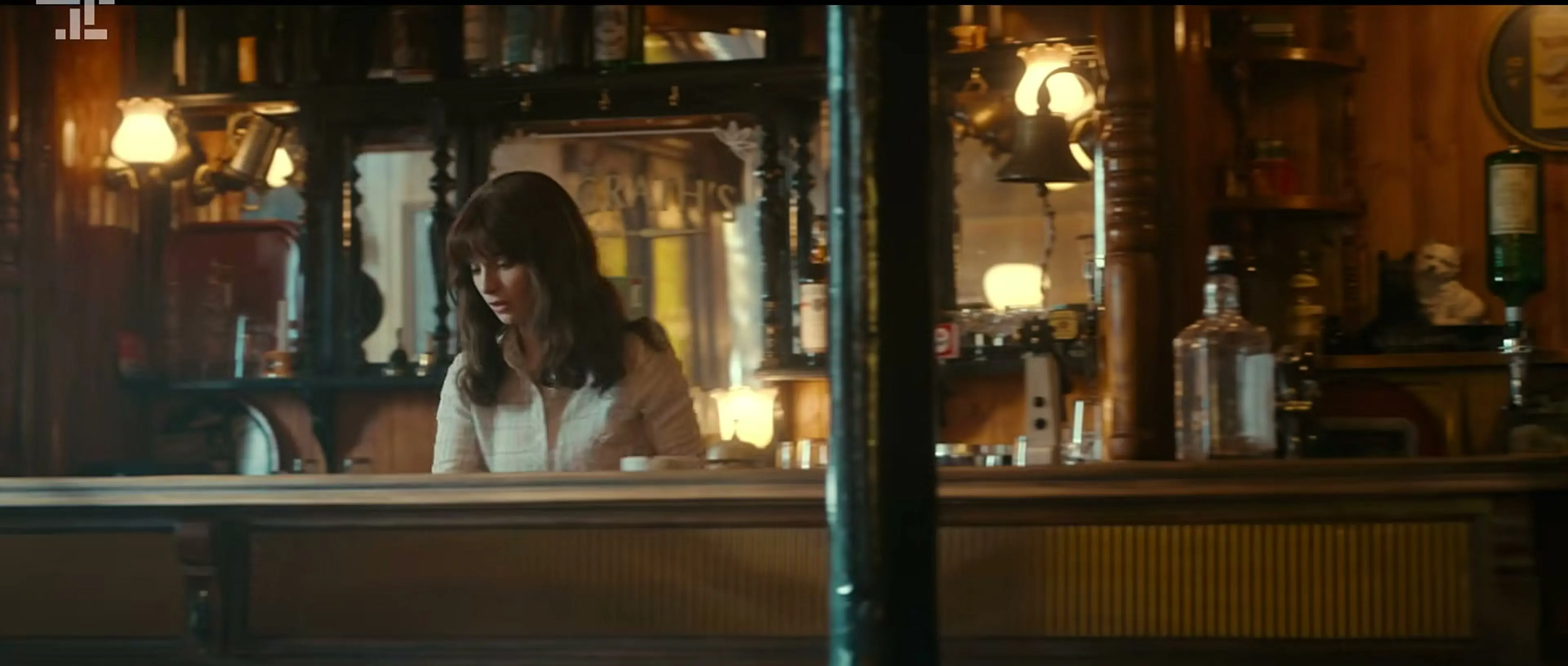 Cushla stands behind the bar in her family pub in Trespasses.