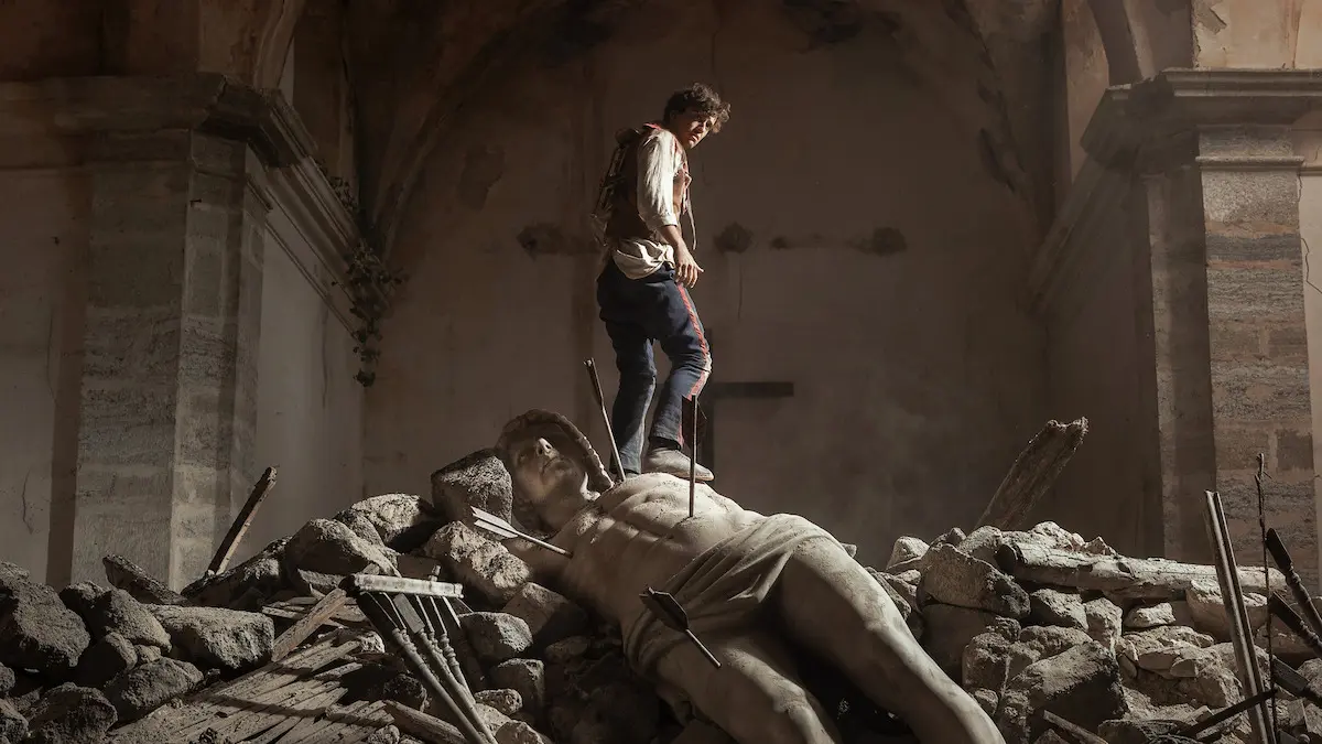 A man stands amid rubble in La Bola Negra.