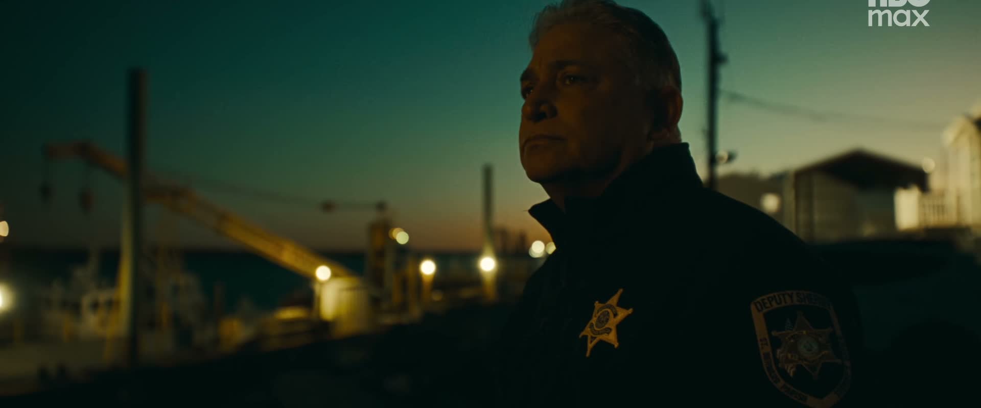 A uniformed officer appears in the trailer.