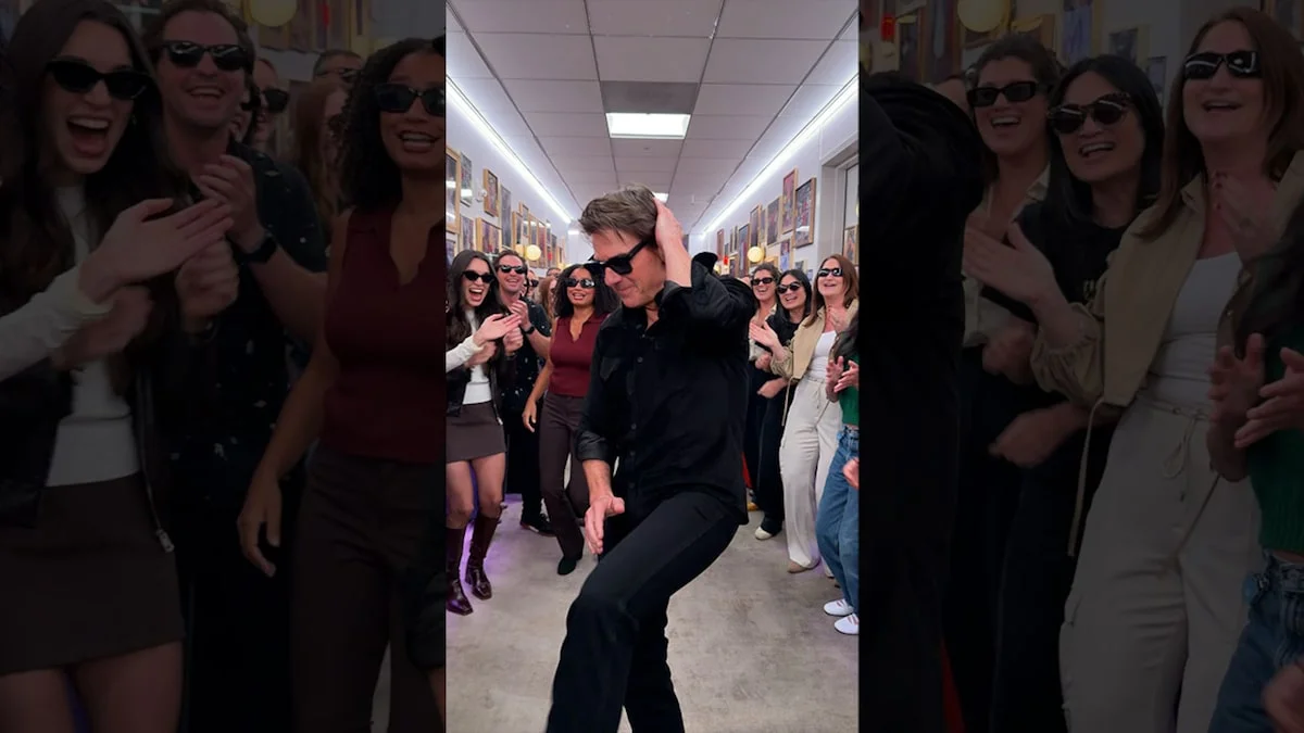 Tom Cruise in black clothes and sunglasses dances between two rows of Jennifer Hudson Show staff.