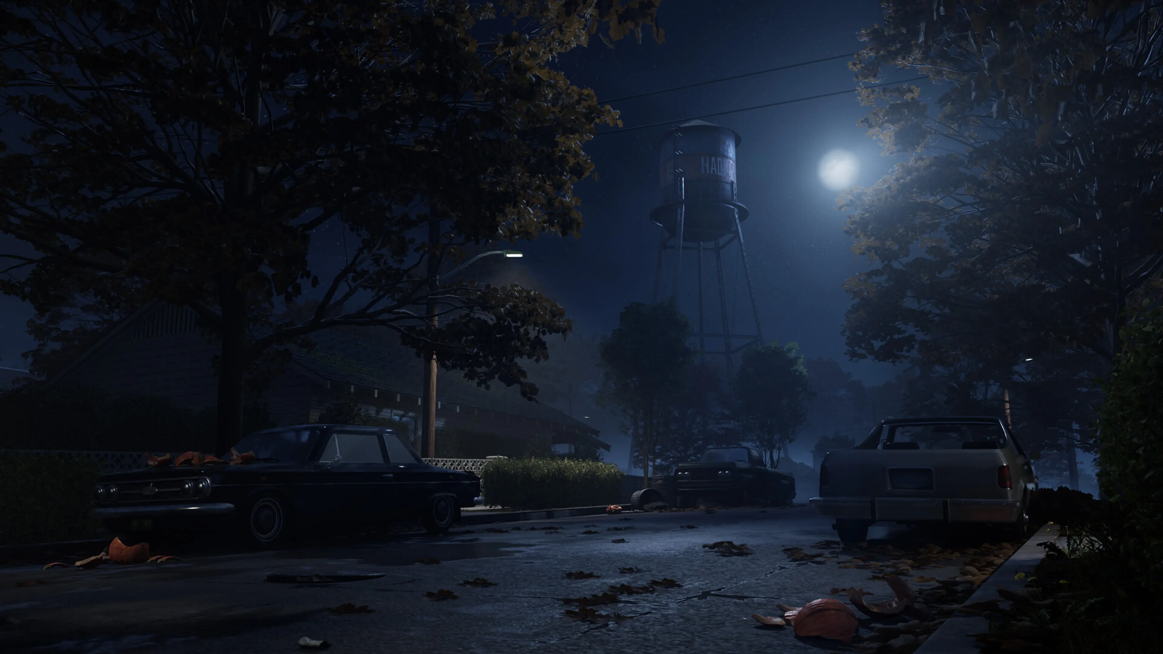 A moonlit East Haddonfield street leads toward a water tower in Halloween: The Game.