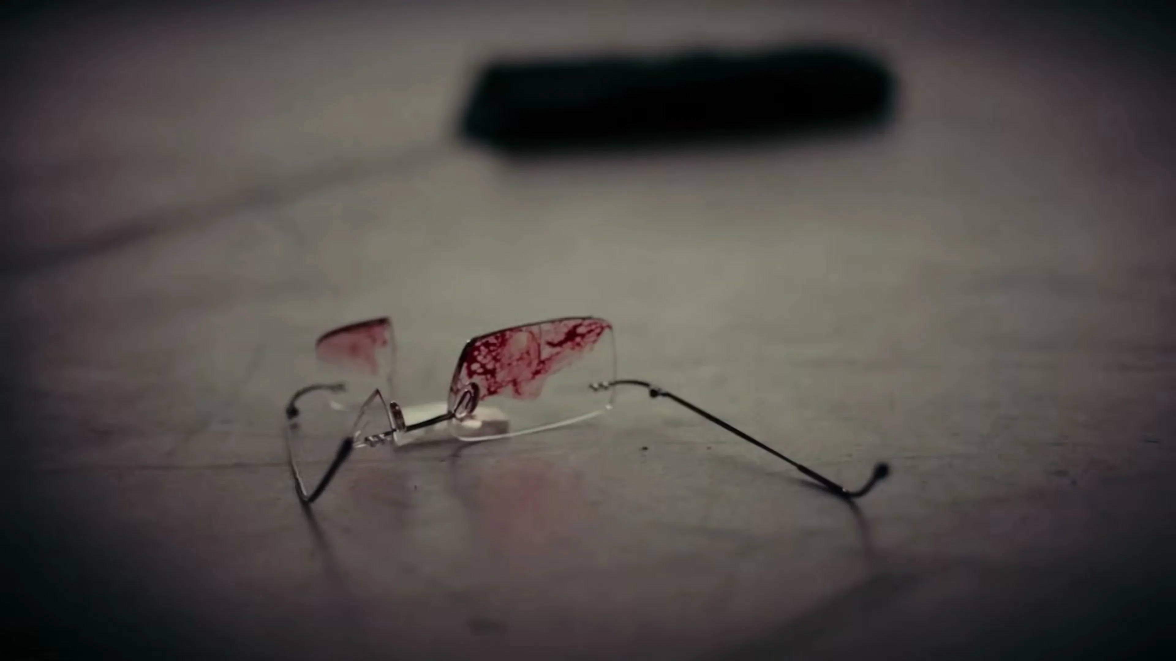 Salman Rushdie’s damaged glasses rest on a hospital surface.