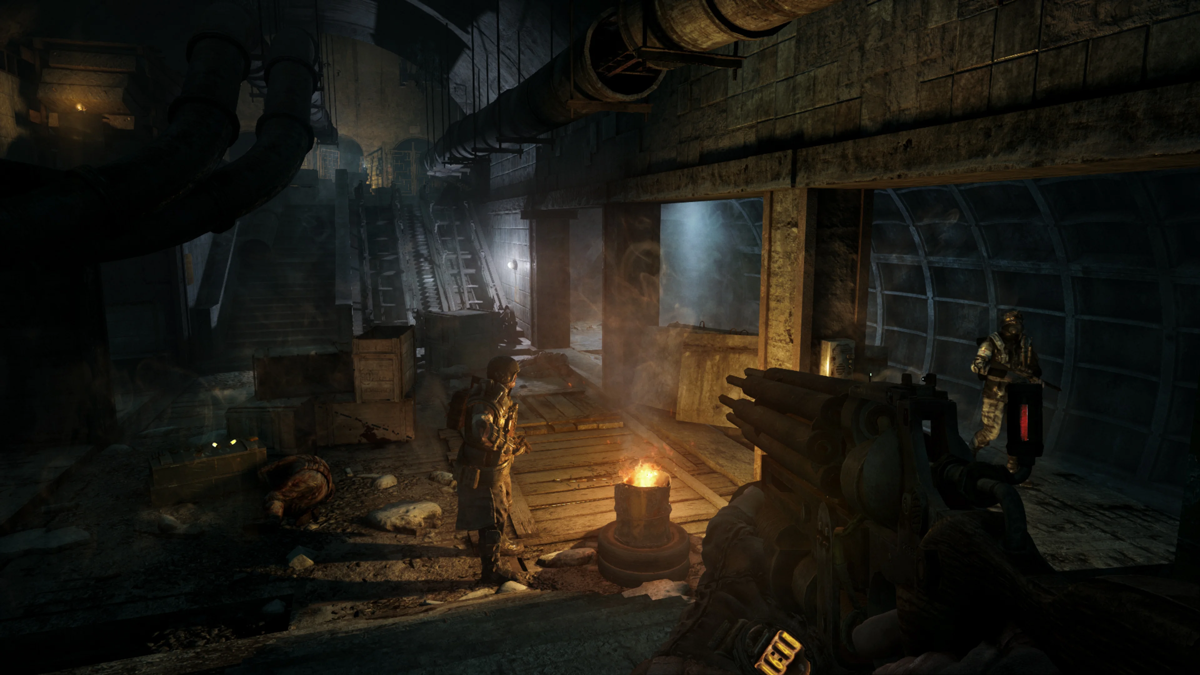 A Ranger stands near a fire in an underground passage in Metro 2033 Redux.