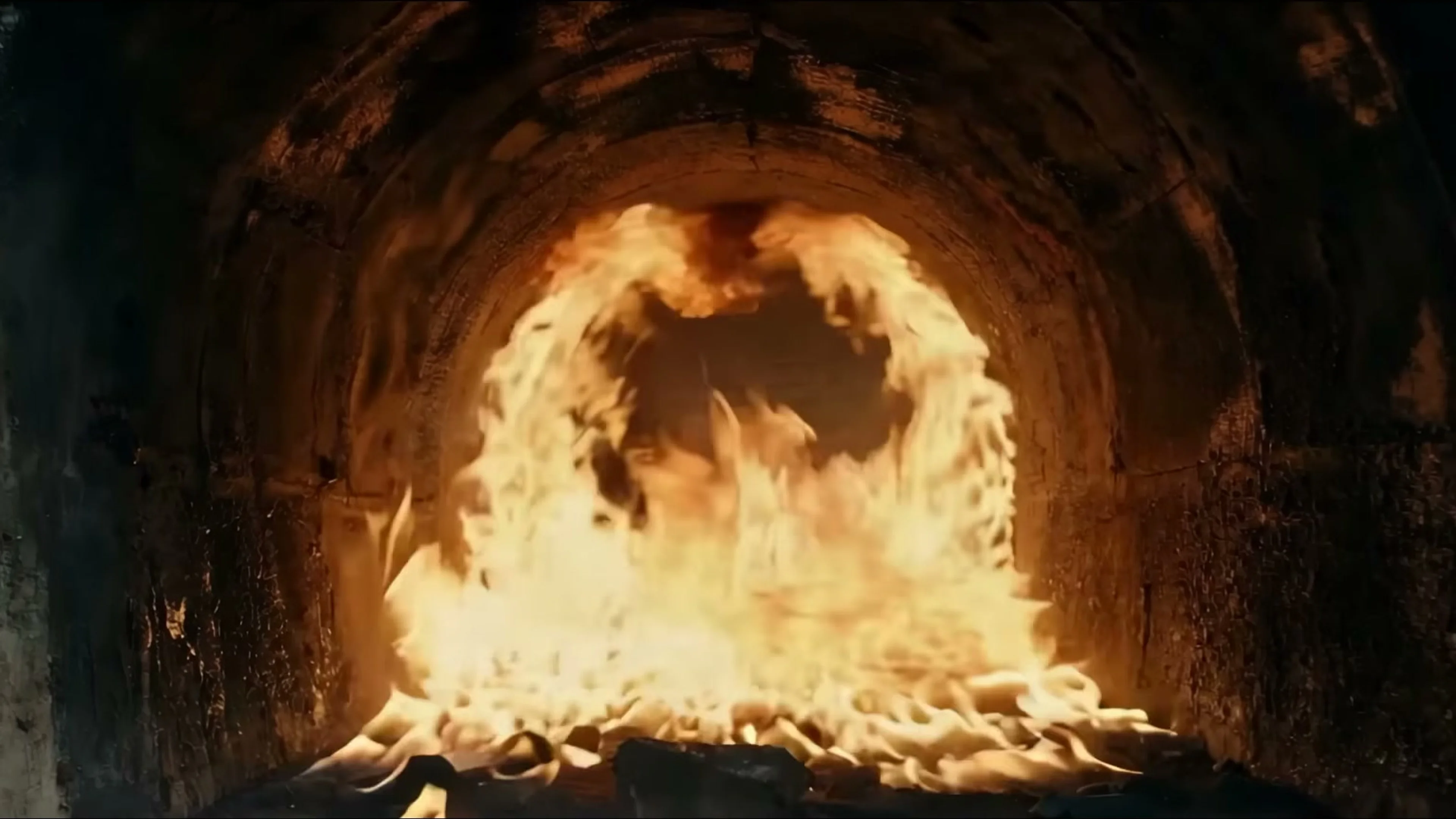 A huge circular furnace burns inside a stone chamber.