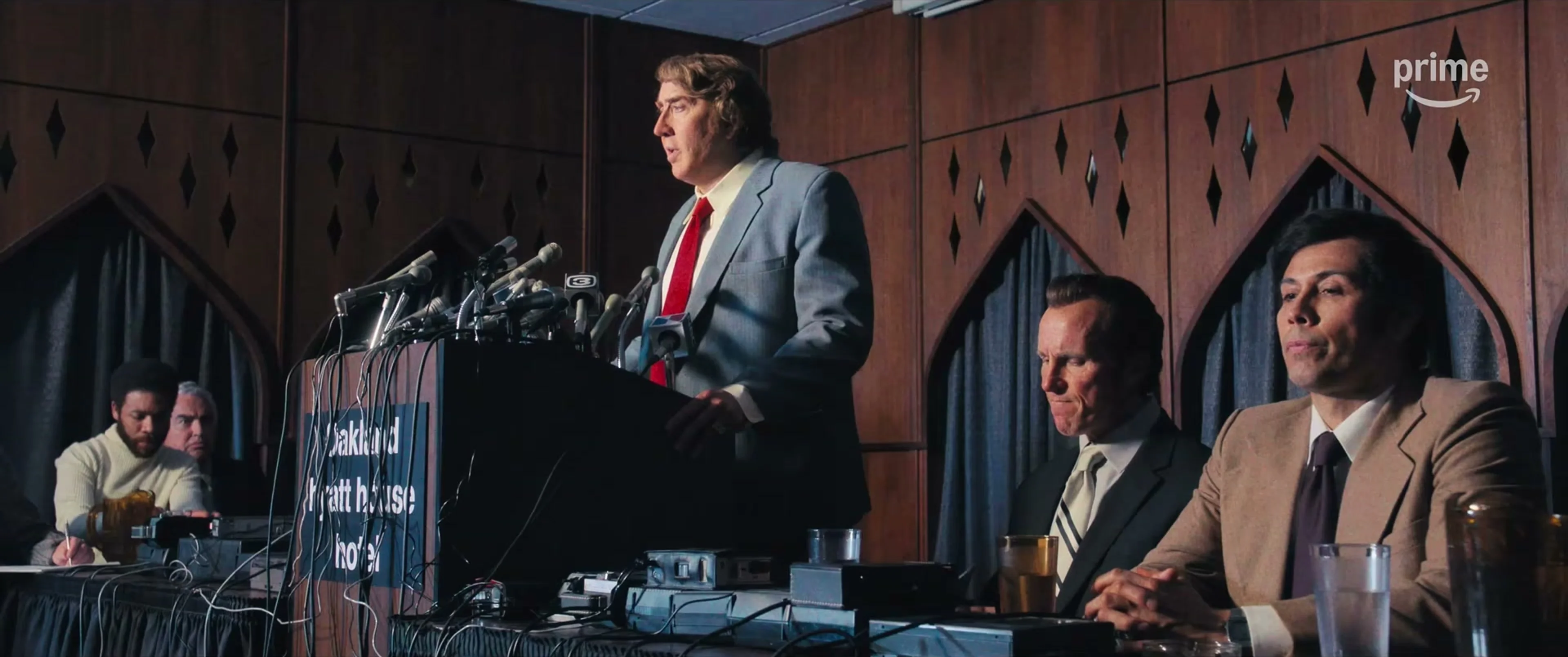 Nicolas Cage as John Madden addresses reporters at a press conference in Madden.