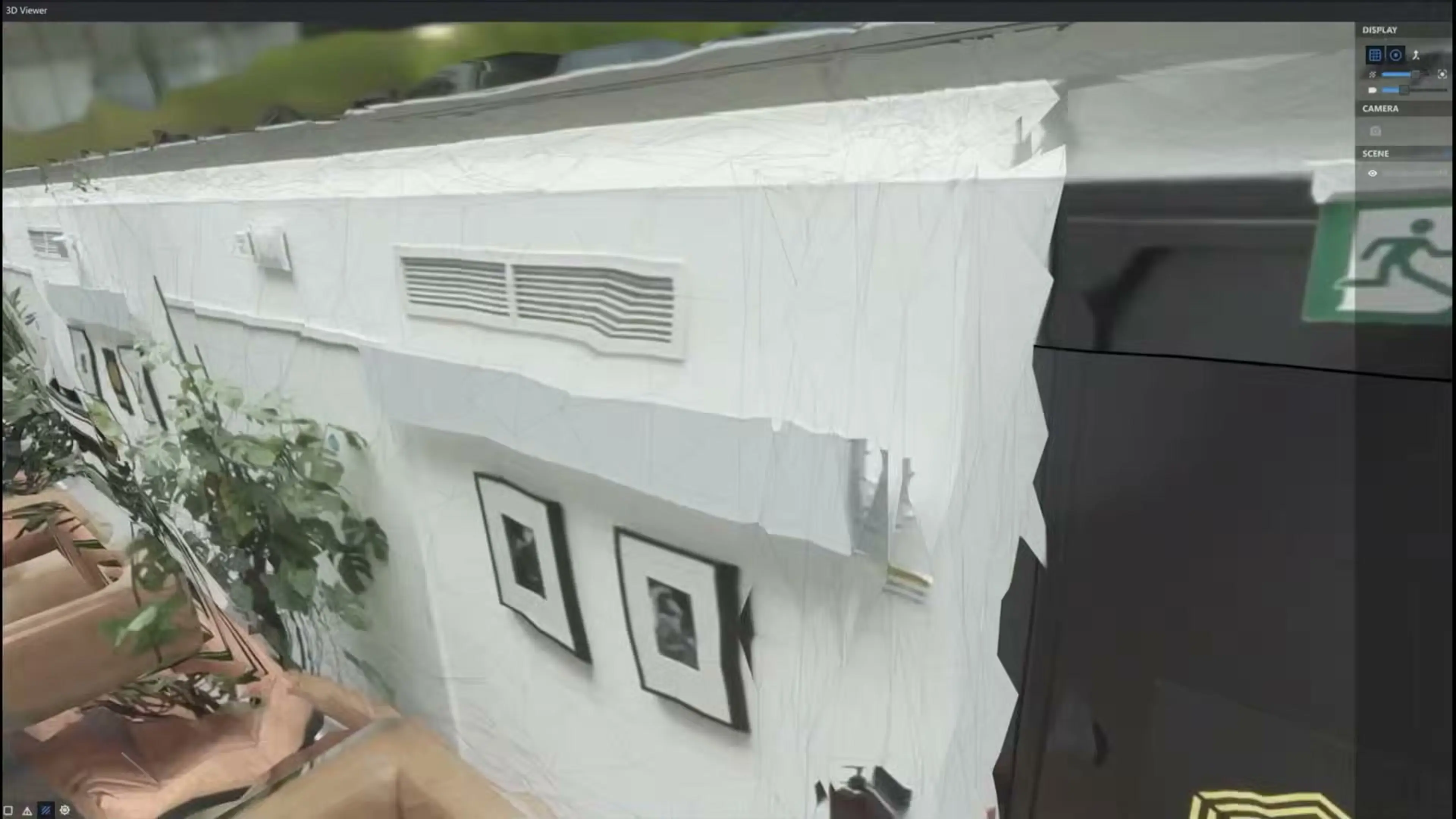 A computer display shows a three-dimensional view of a room with plants and an exit door.