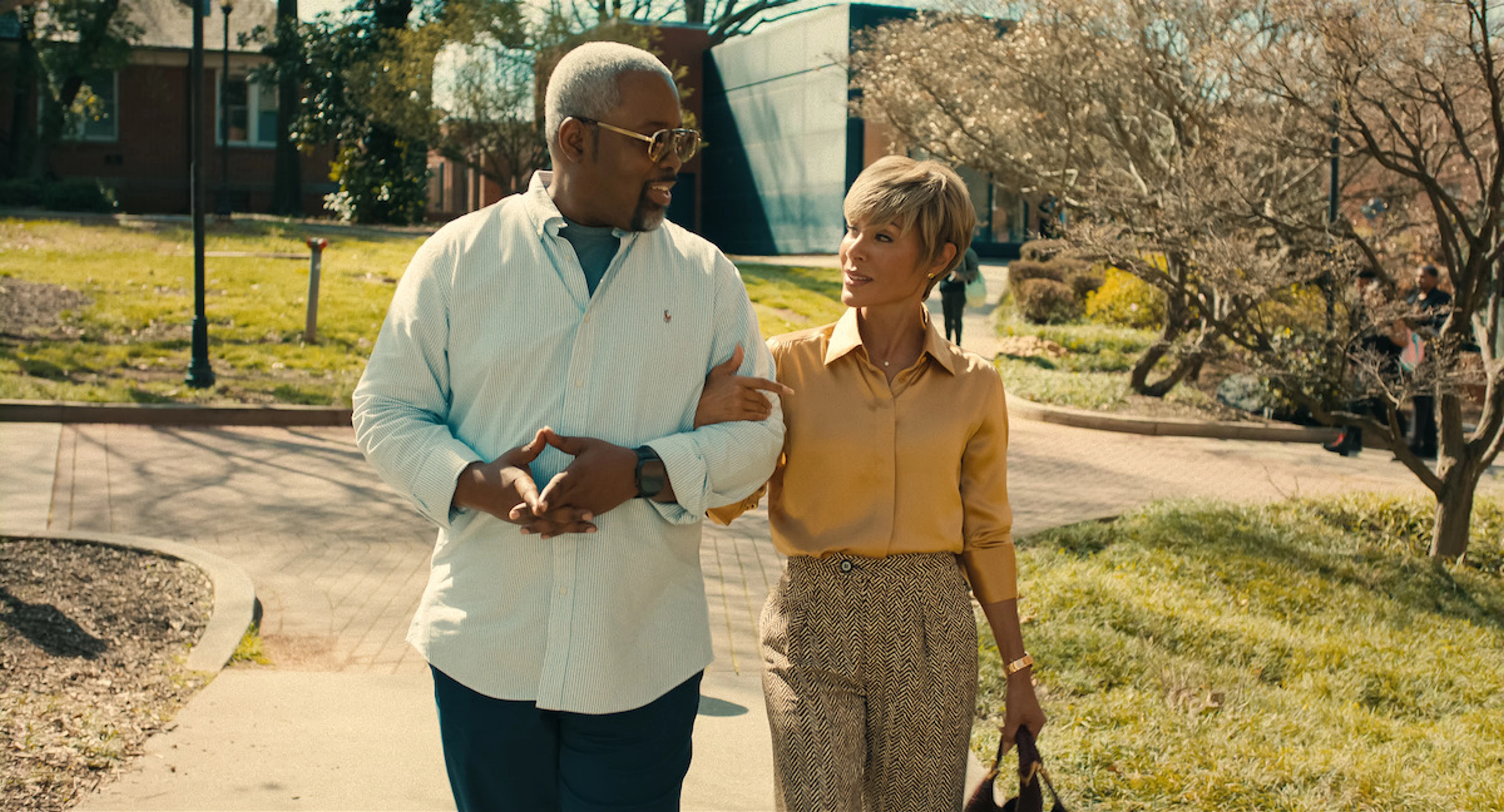 Two returning A Different World characters walk together across Hillman College.