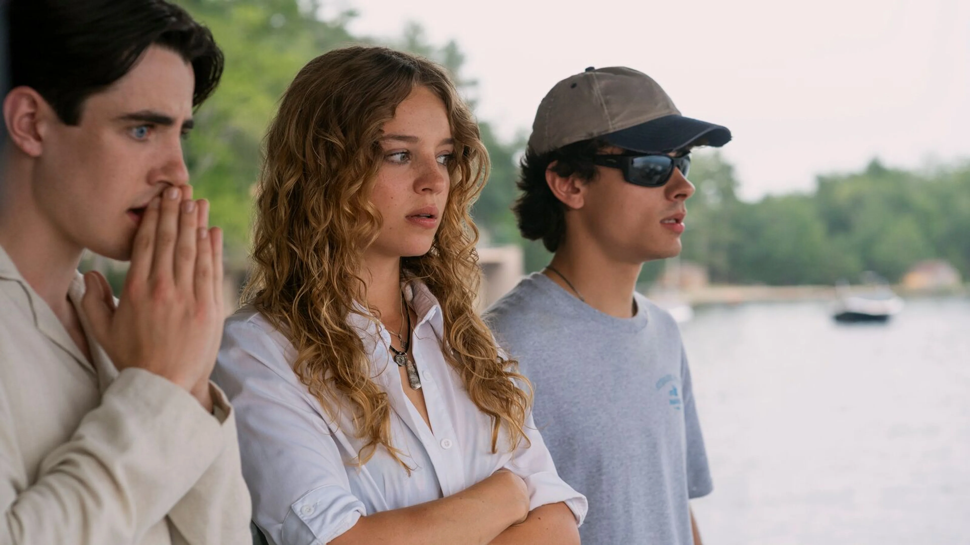 Three Sterling Point characters stand together beside the water in an official Season 1 still.