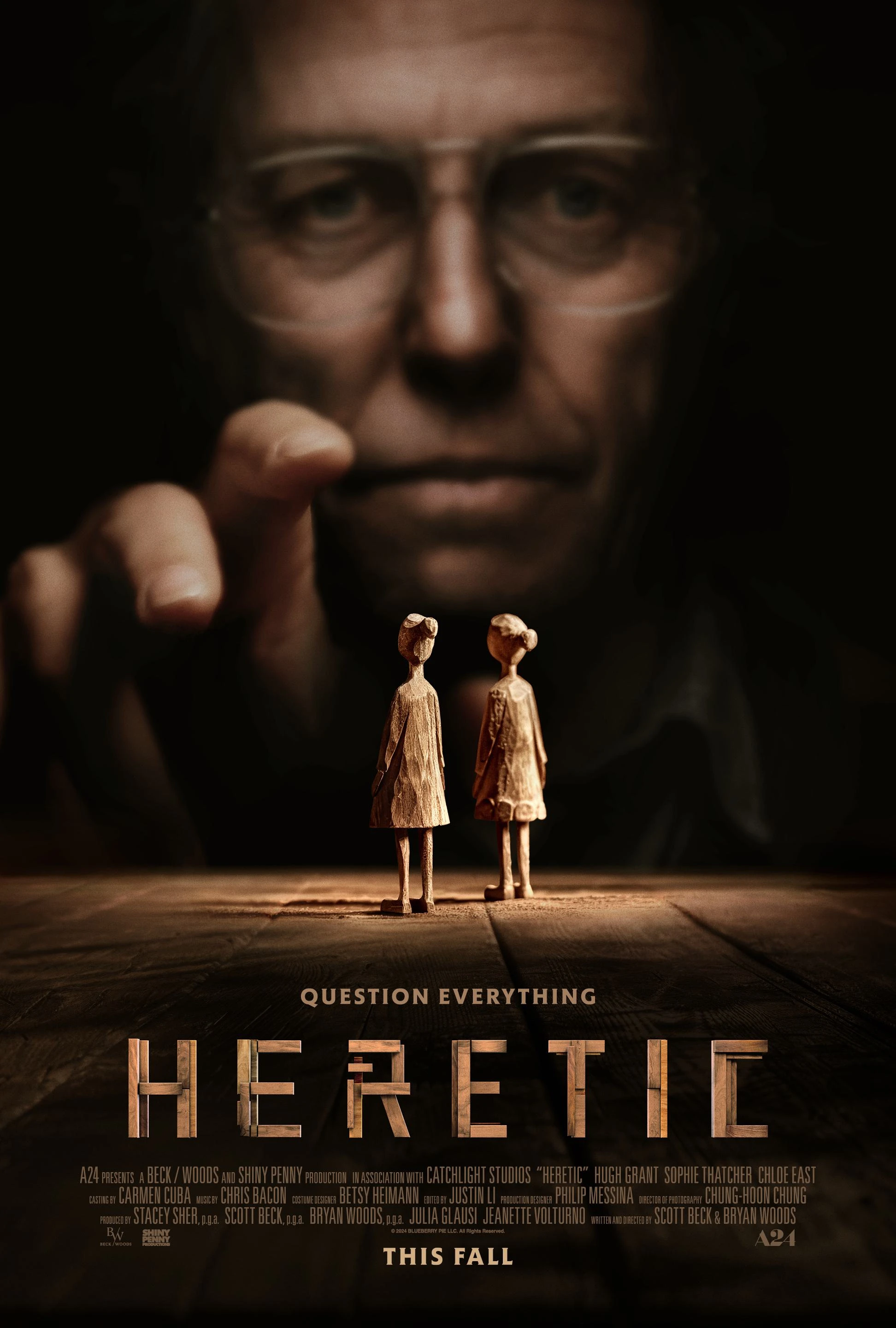 Official Heretic poster showing Hugh Grant above two small figures of the missionaries, with the film title and credits.