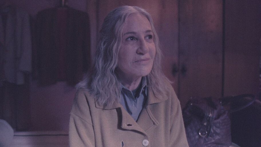 A woman sits in a dark room in an official My Sad Dead preview image.