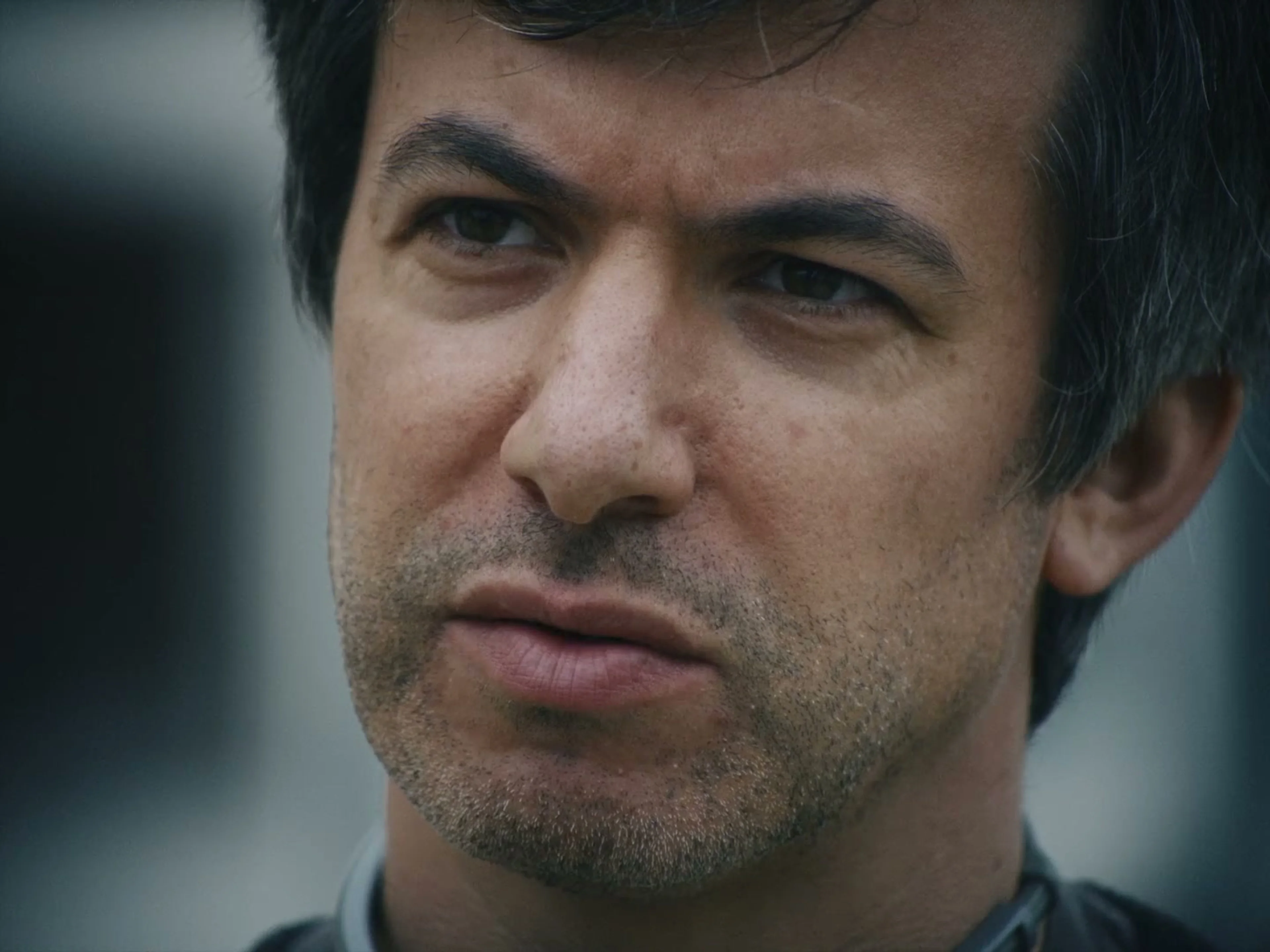 Nathan Fielder looks toward Elizabeth Holmes during a tense conversation in the official trailer.
