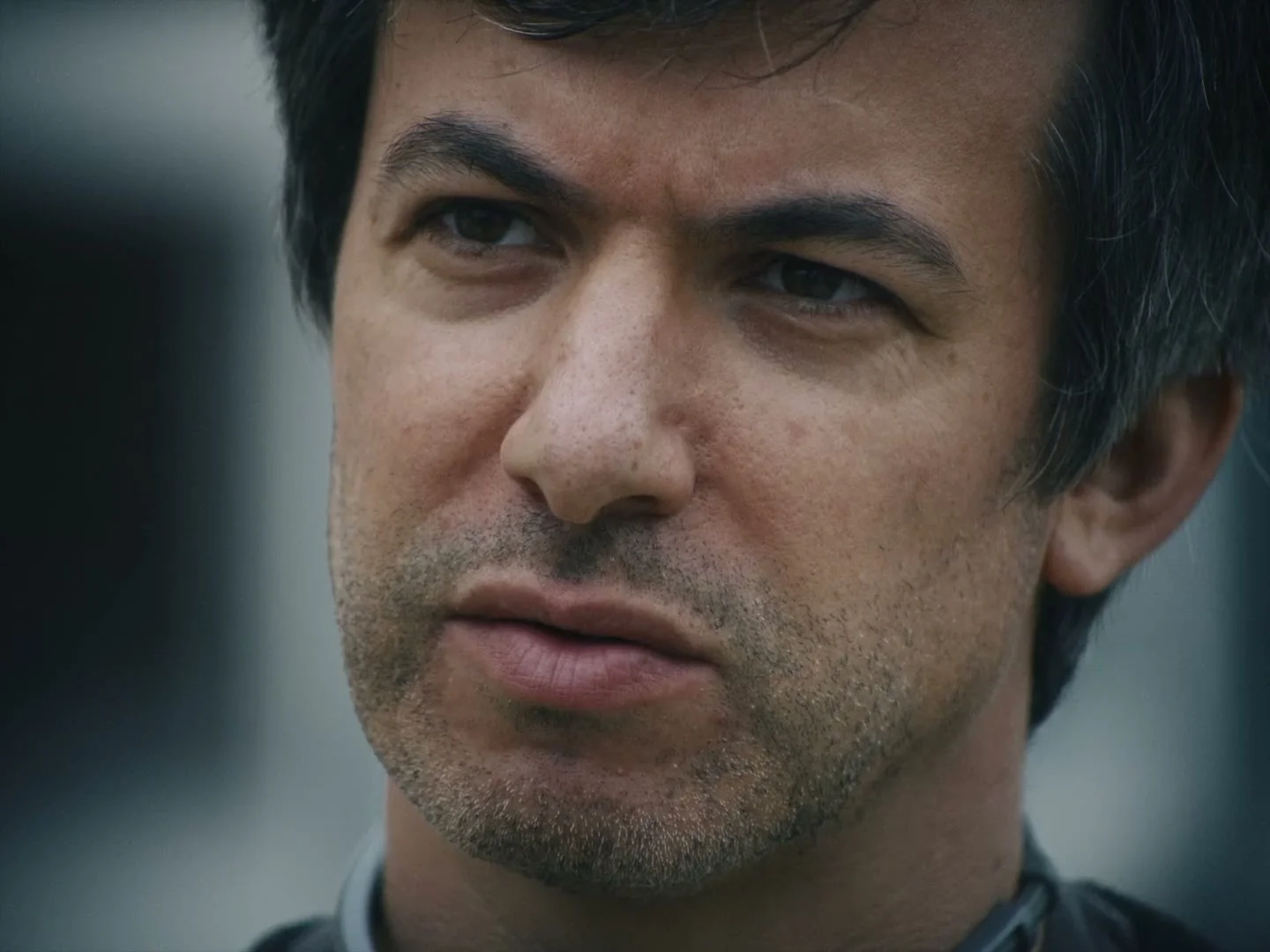 Nathan Fielder looks toward Elizabeth Holmes during a tense conversation in the official trailer.