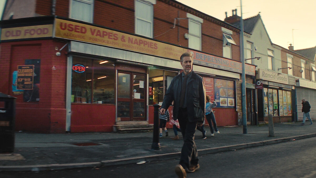 Paddy Considine as Detective John Blackmere walks along a city street in Netflix’s first-look image.